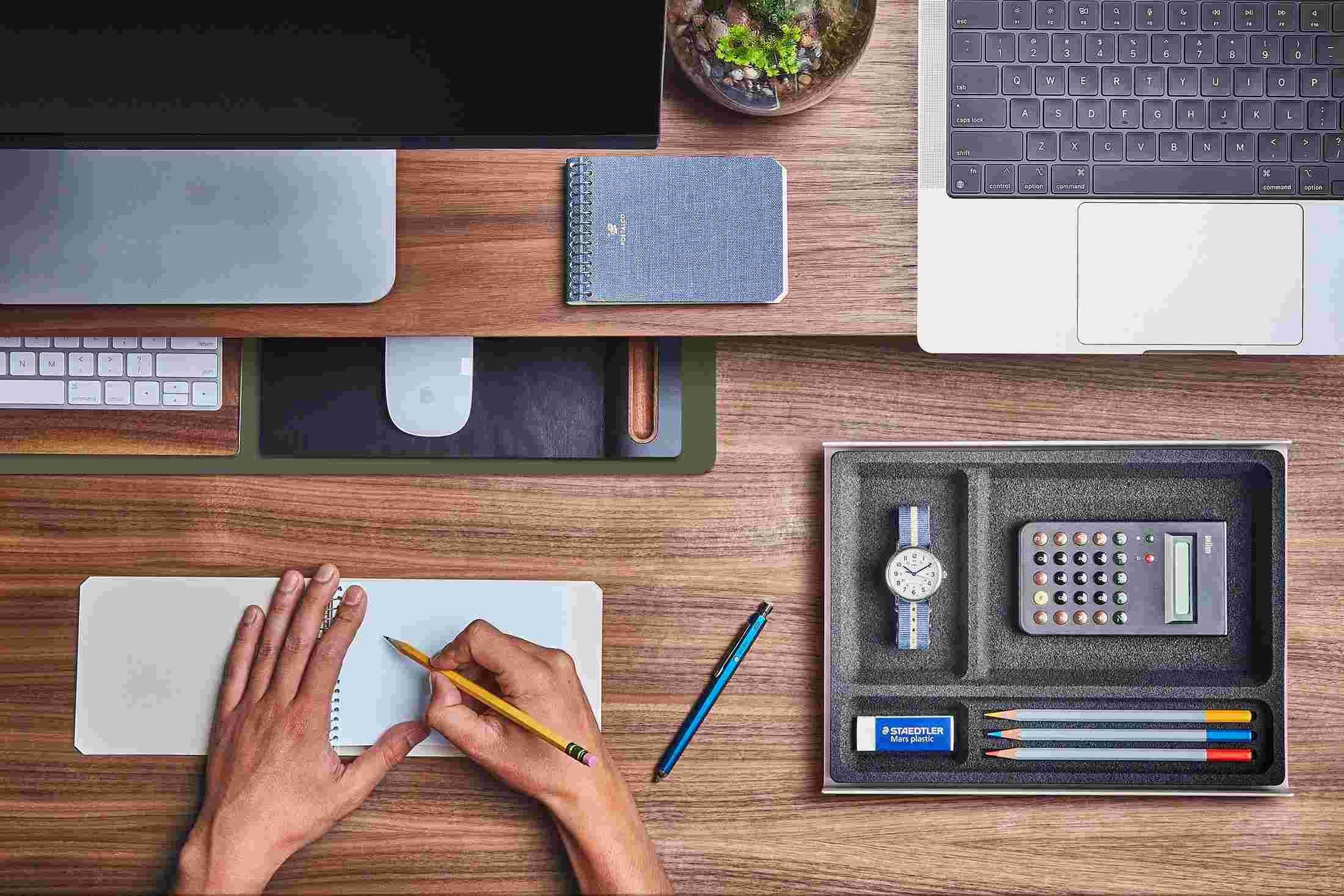 The Small Dark Green Desk Pad tucked under the Walnut Desk Shelf, creating space to sketch and write.