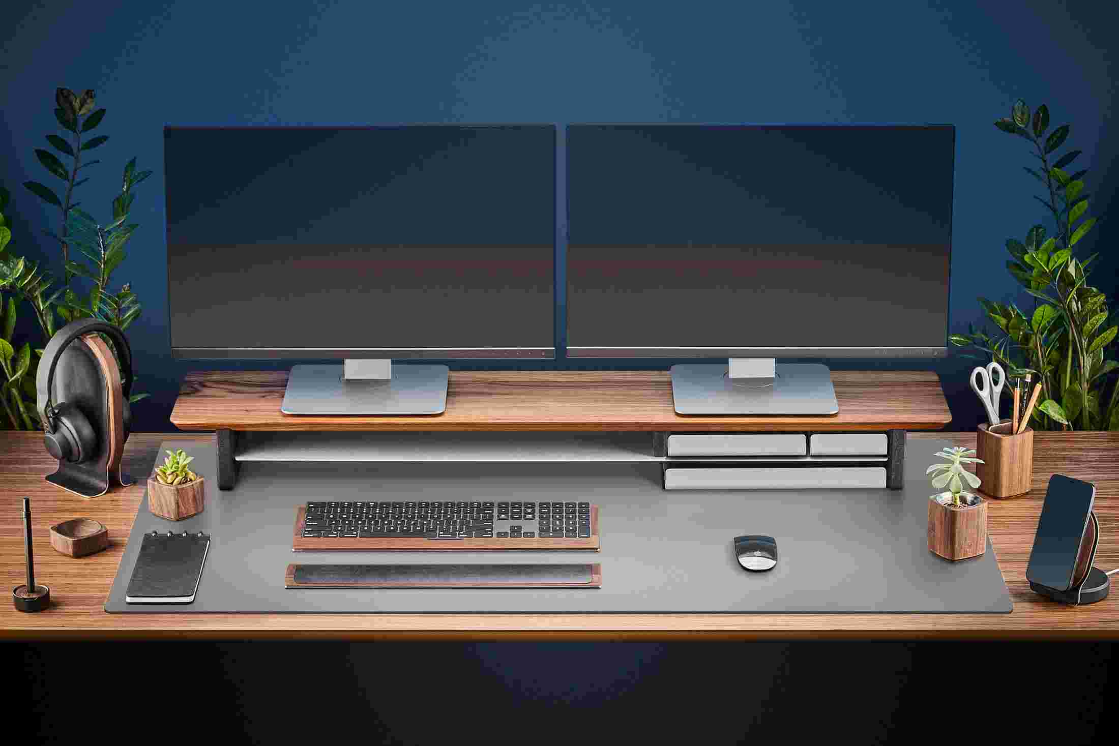 The Extra Large Matte Desk Pad in Dark Grey covering almost an entire desktop, in use with the Walnut Desk Shelf System.