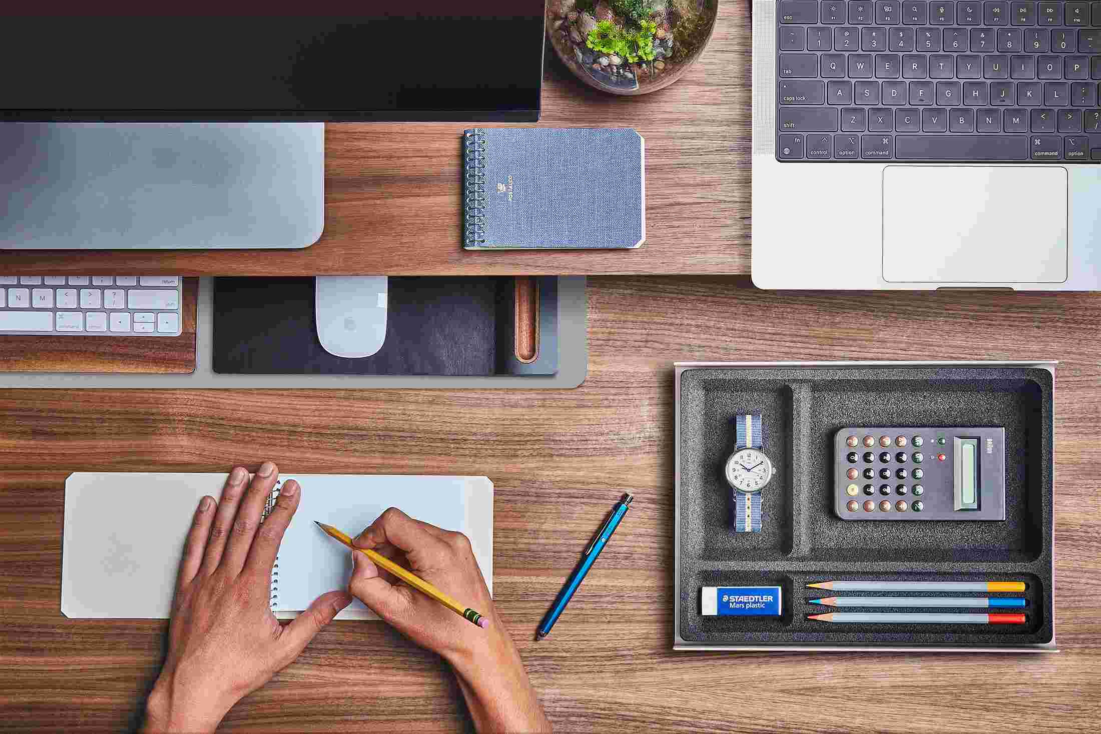 The Small Dark Grey Desk Pad tucked under the Walnut Desk Shelf, creating space to sketch and write.