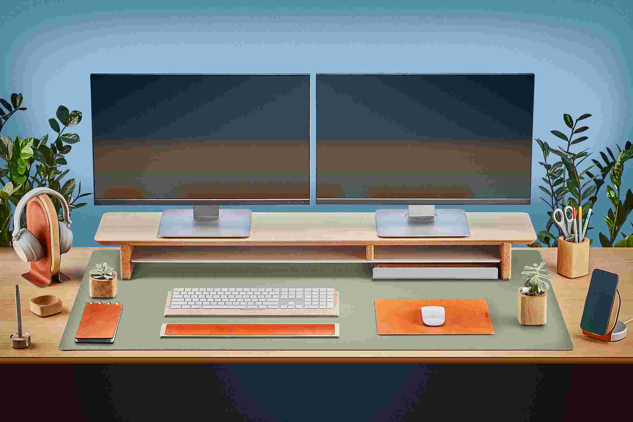 The Extra Large Matte Desk Pad in Light Green covering almost an entire desktop, in use with the Maple Desk Shelf System.