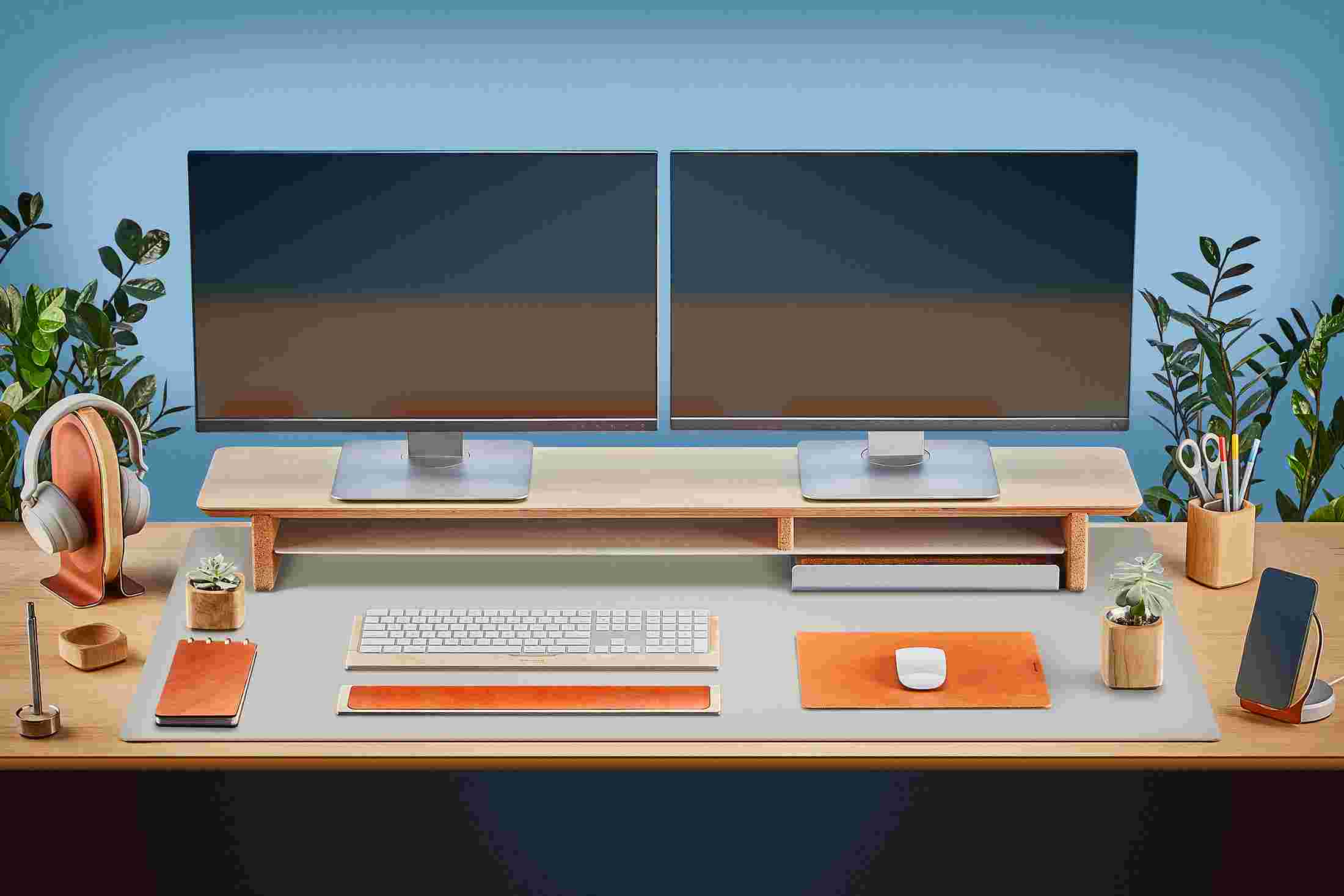 The Extra Large Matte Desk Pad in Light Grey covering almost an entire desktop, in use with the Maple Desk Shelf System.