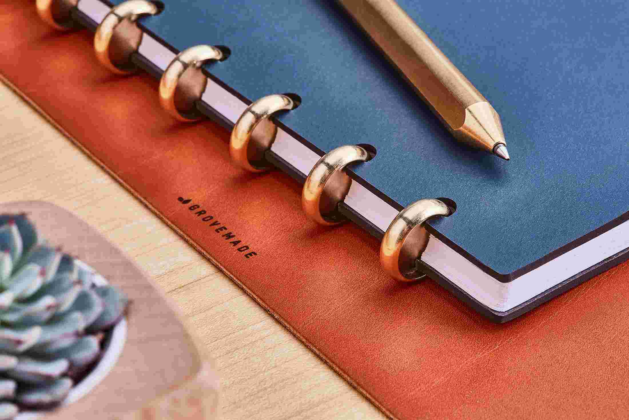 Detail of the brass discs on the Grovemade Navy Blue Discbound Matte Notebook.
