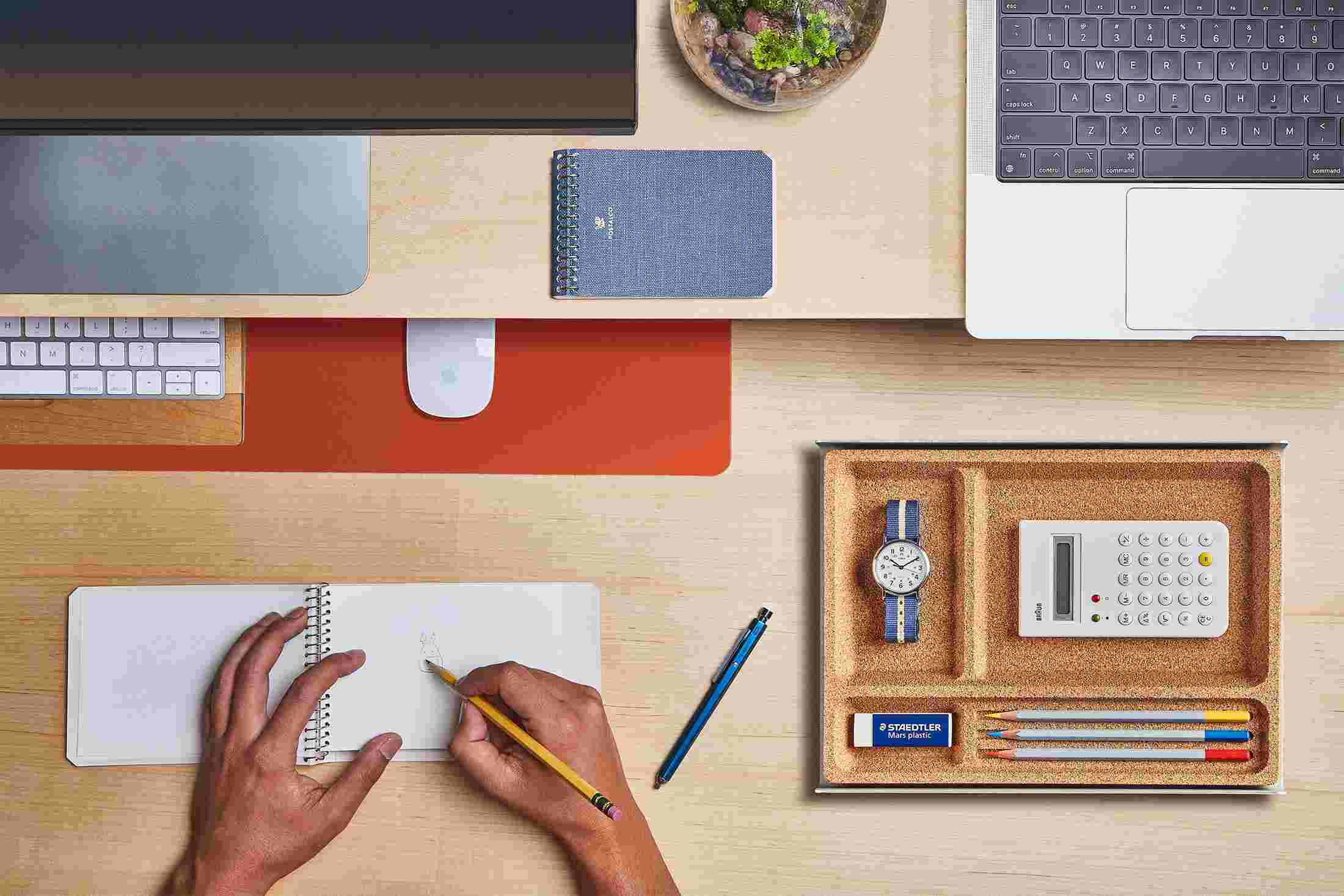 The Small Orange Desk Pad tucked under the Matte Black Desk Shelf, creating space to sketch and write.