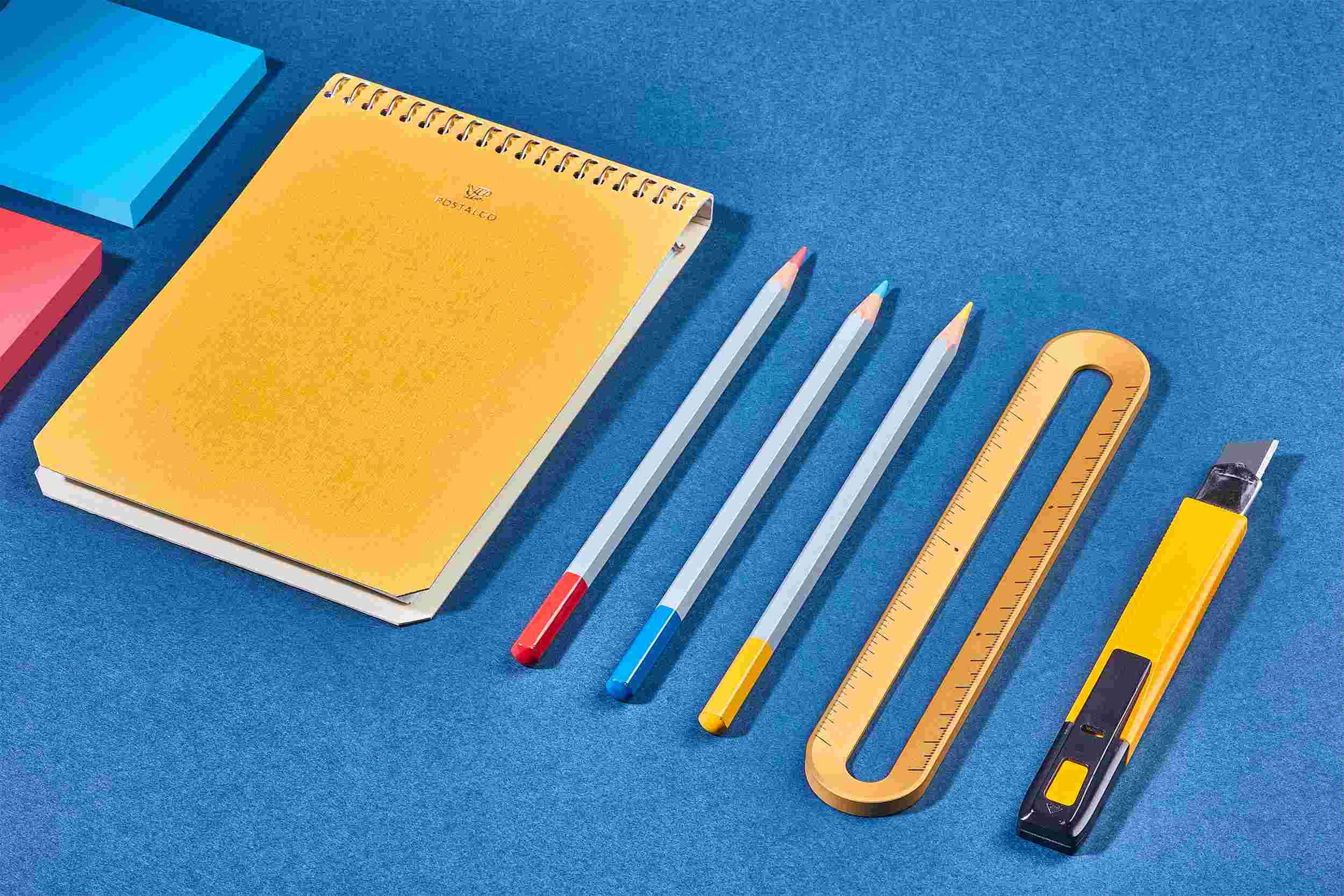 The Grovemade 6-Inch Gold Ruler on blue paper with crafting tools.
