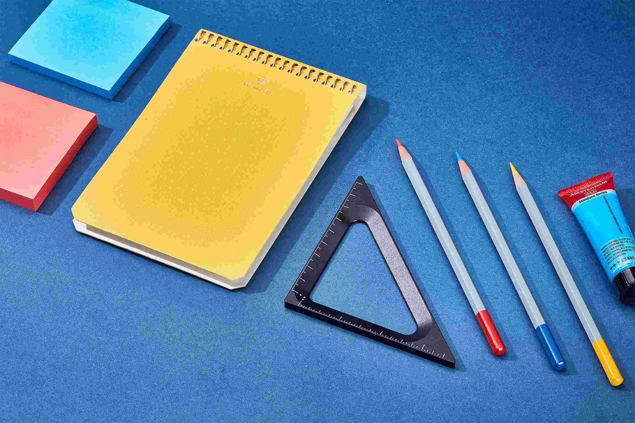 The Grovemade Triangle with various writing tools.
