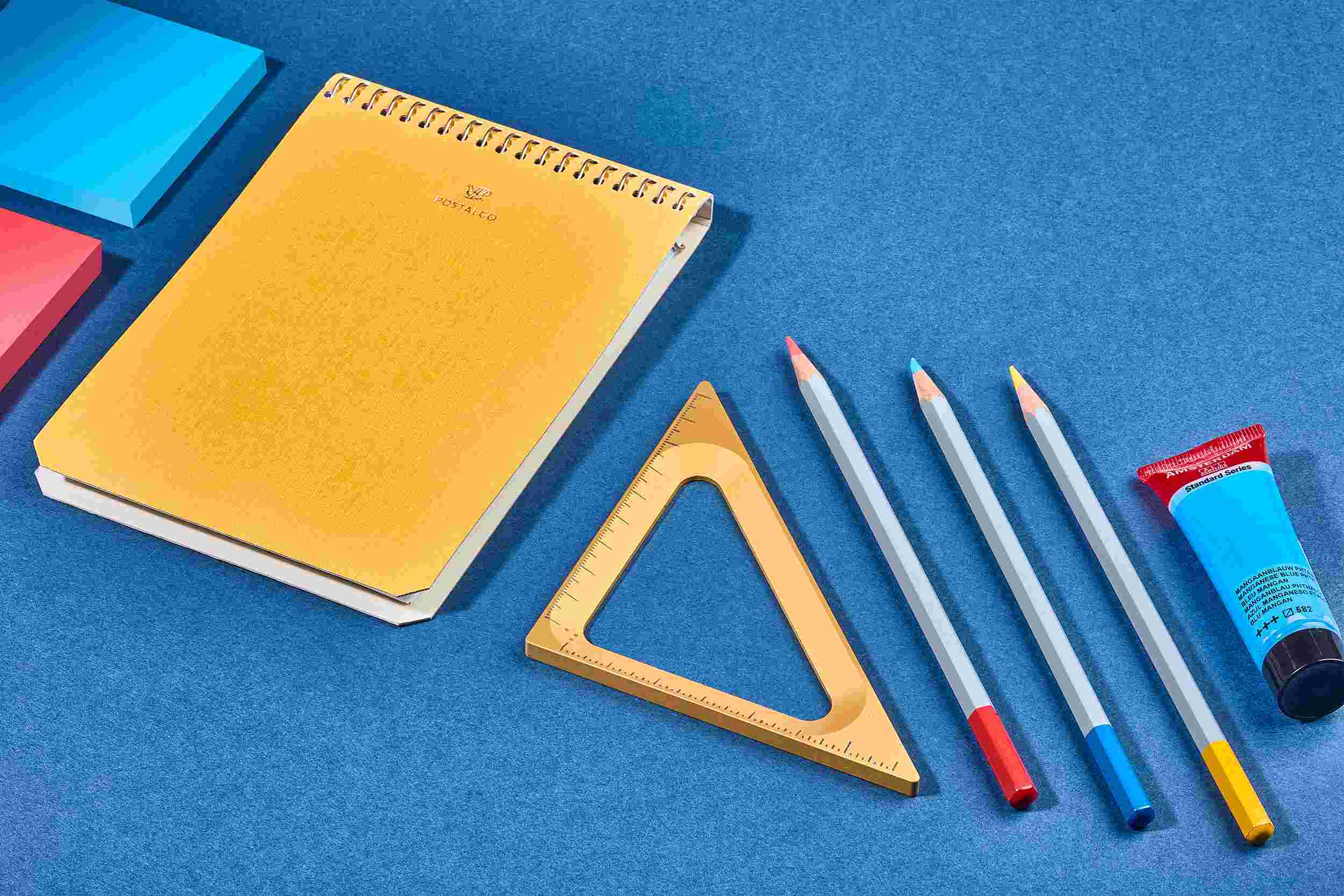 The Grovemade Gold Triangle on blue paper with crafting tools.