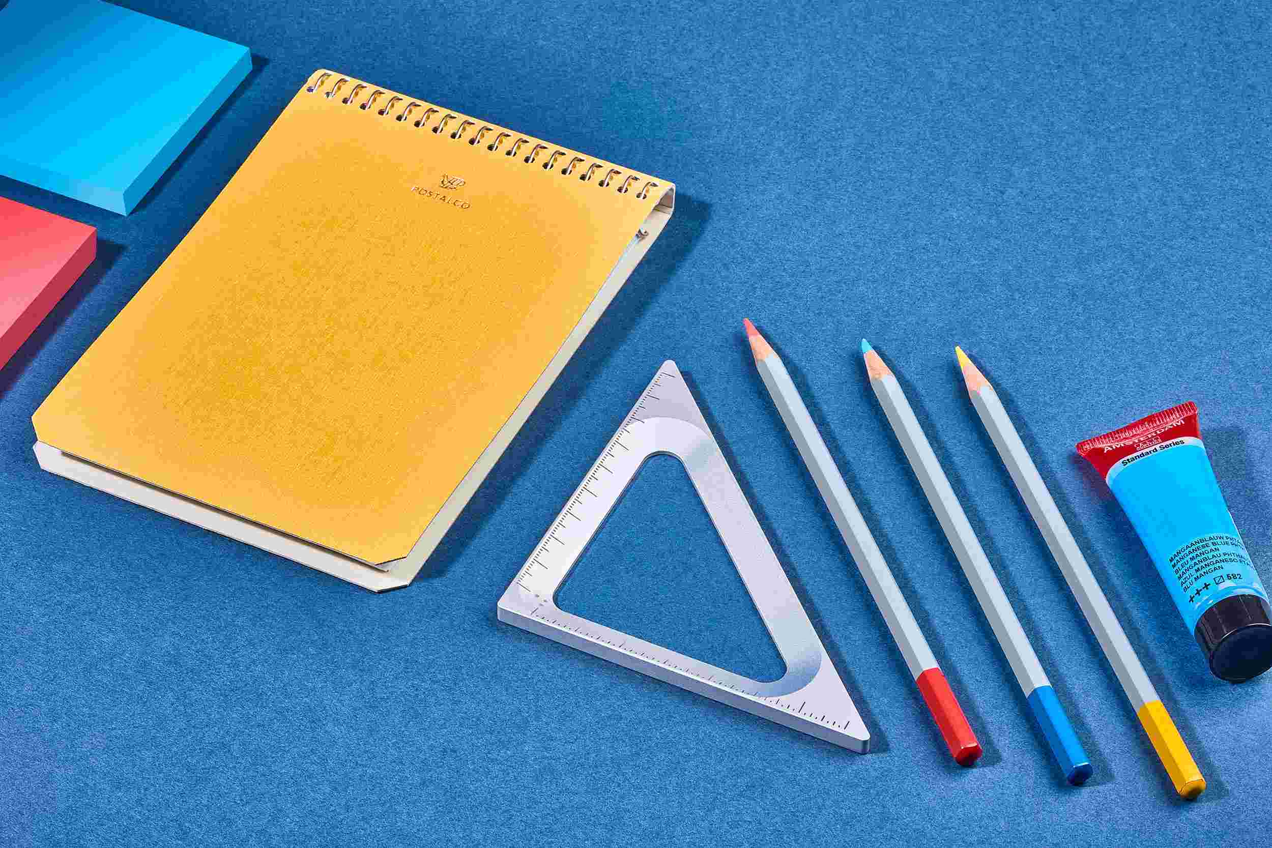 The Grovemade Silver Triangle on blue paper with crafting tools.