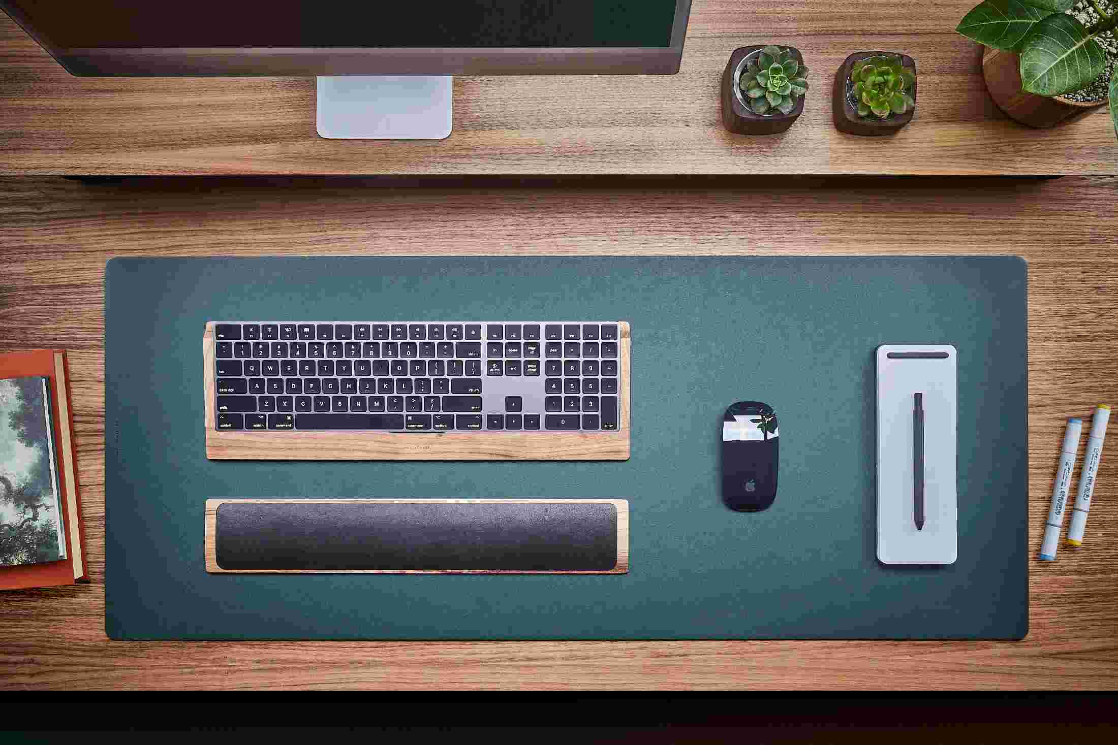 Overhead view of the green desk pad with walnut keyboard tray and wrist rest.
