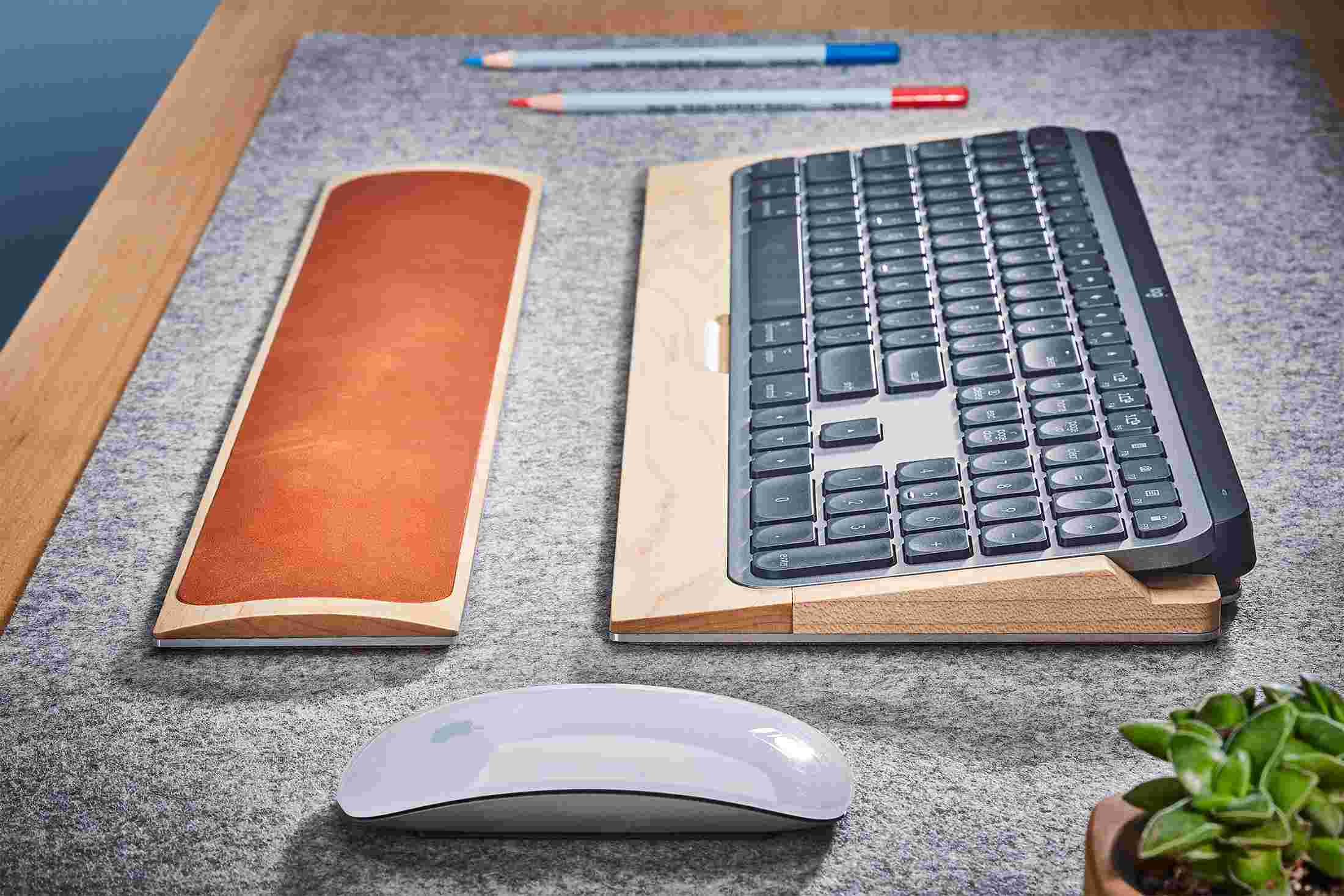 Side view detail of the steel and maple wood keyboard tray for MX Keys.
