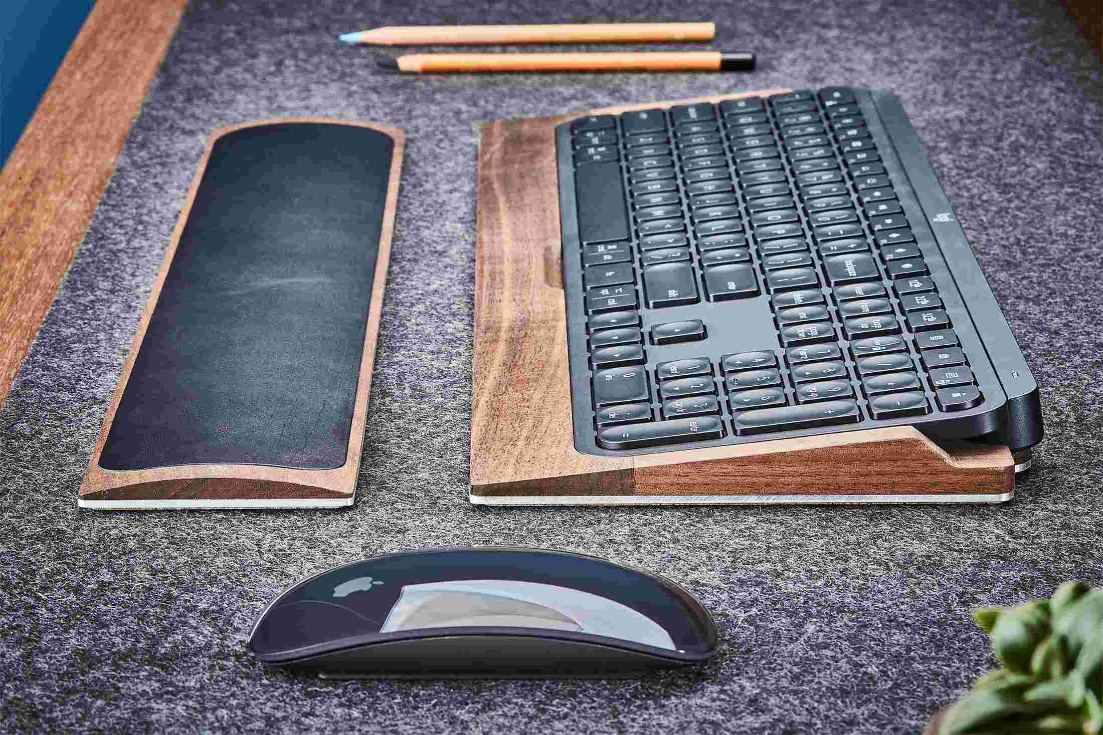 Side view detail of the steel and walnut wood keyboard tray for MX Keys.