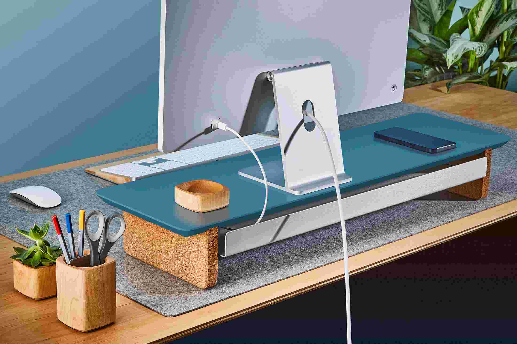 Rear view of medium navy blue desk shelf, showing hidden cord management.