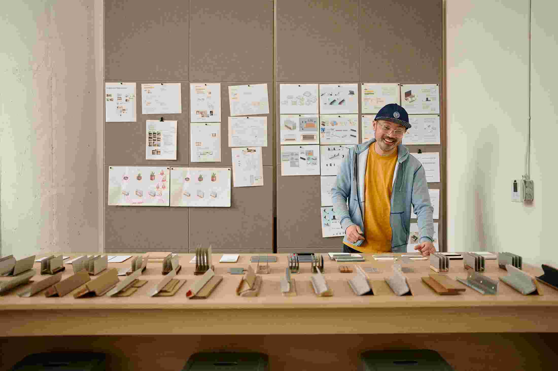Ken in front of dozens of rough physical mockups.