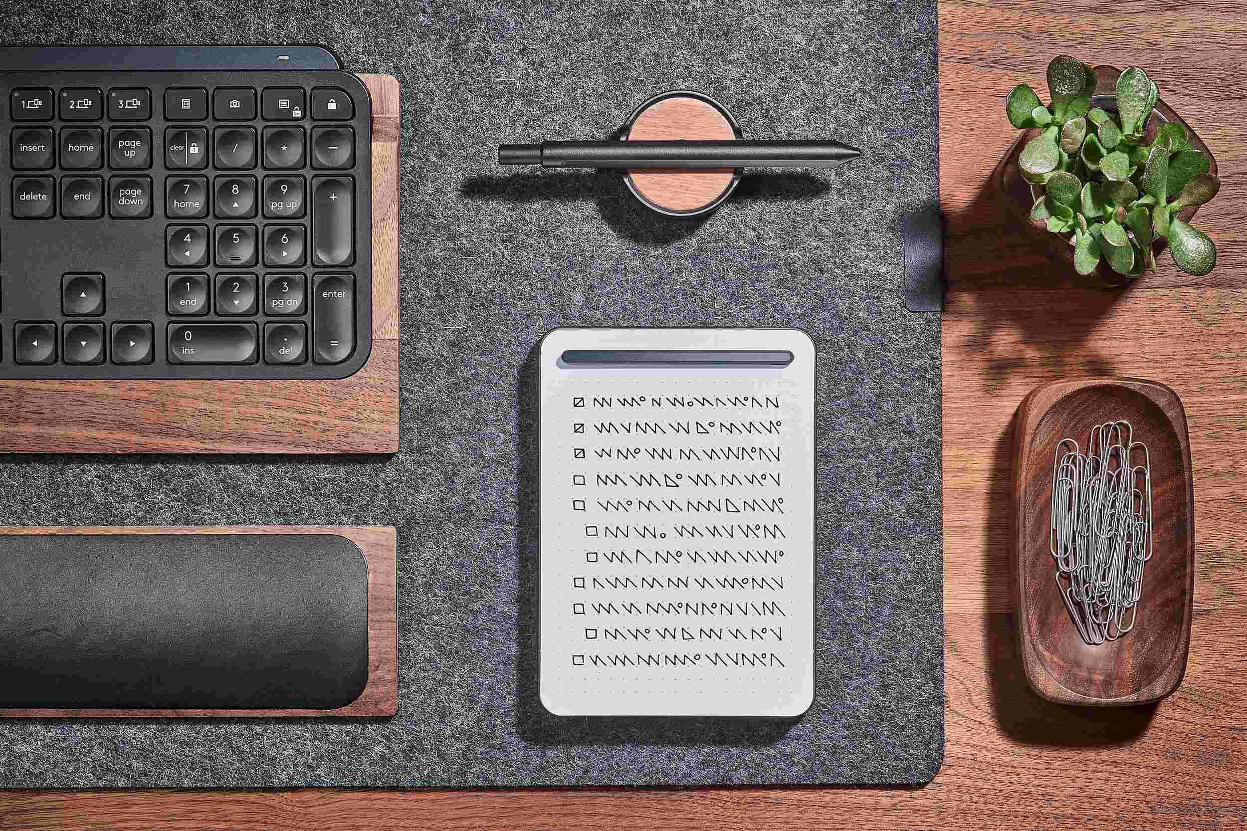 Overhead view of the small black notepad and matching black pen set.