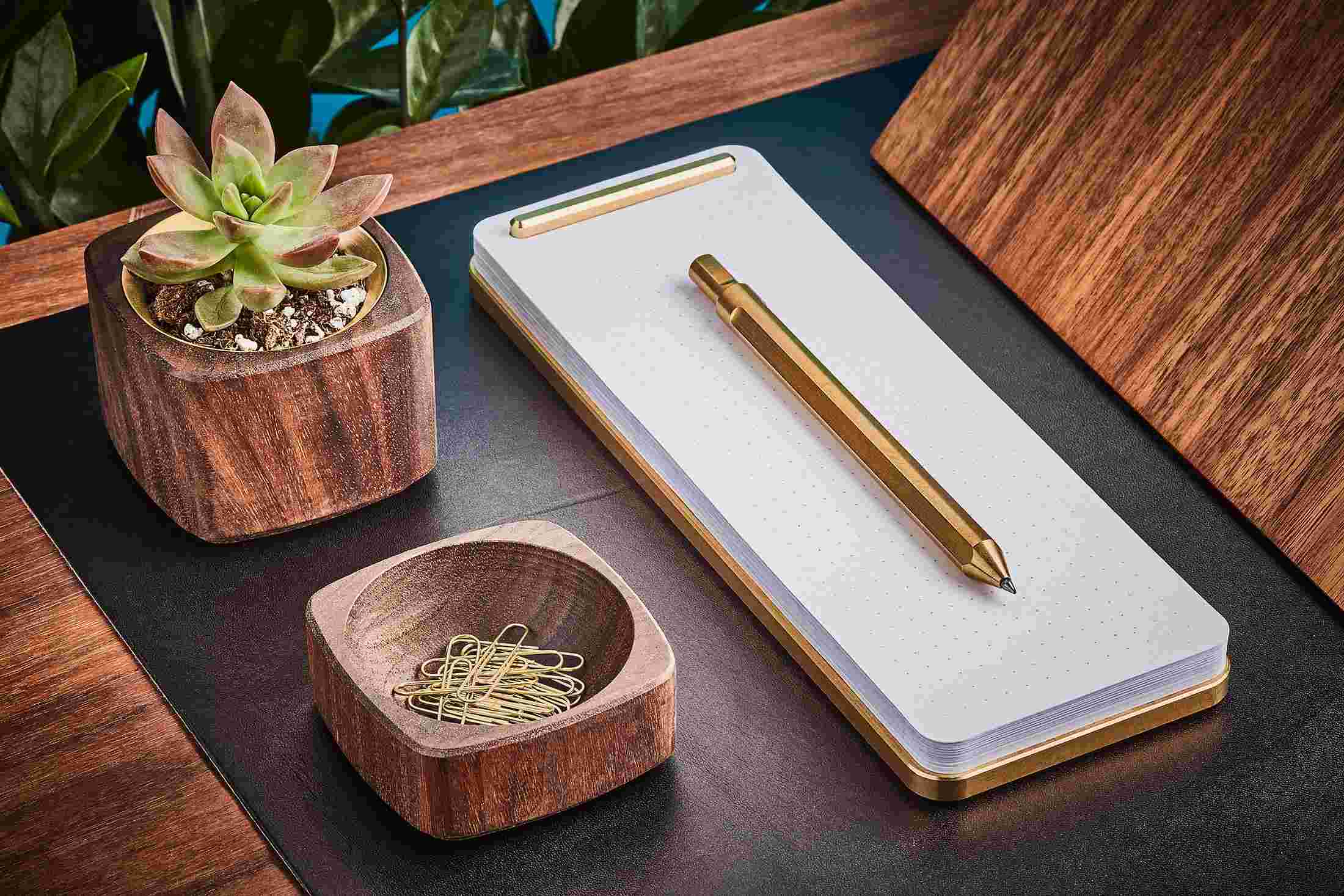 Brass looseleaf notepad desk station, with walnut wood accessories.