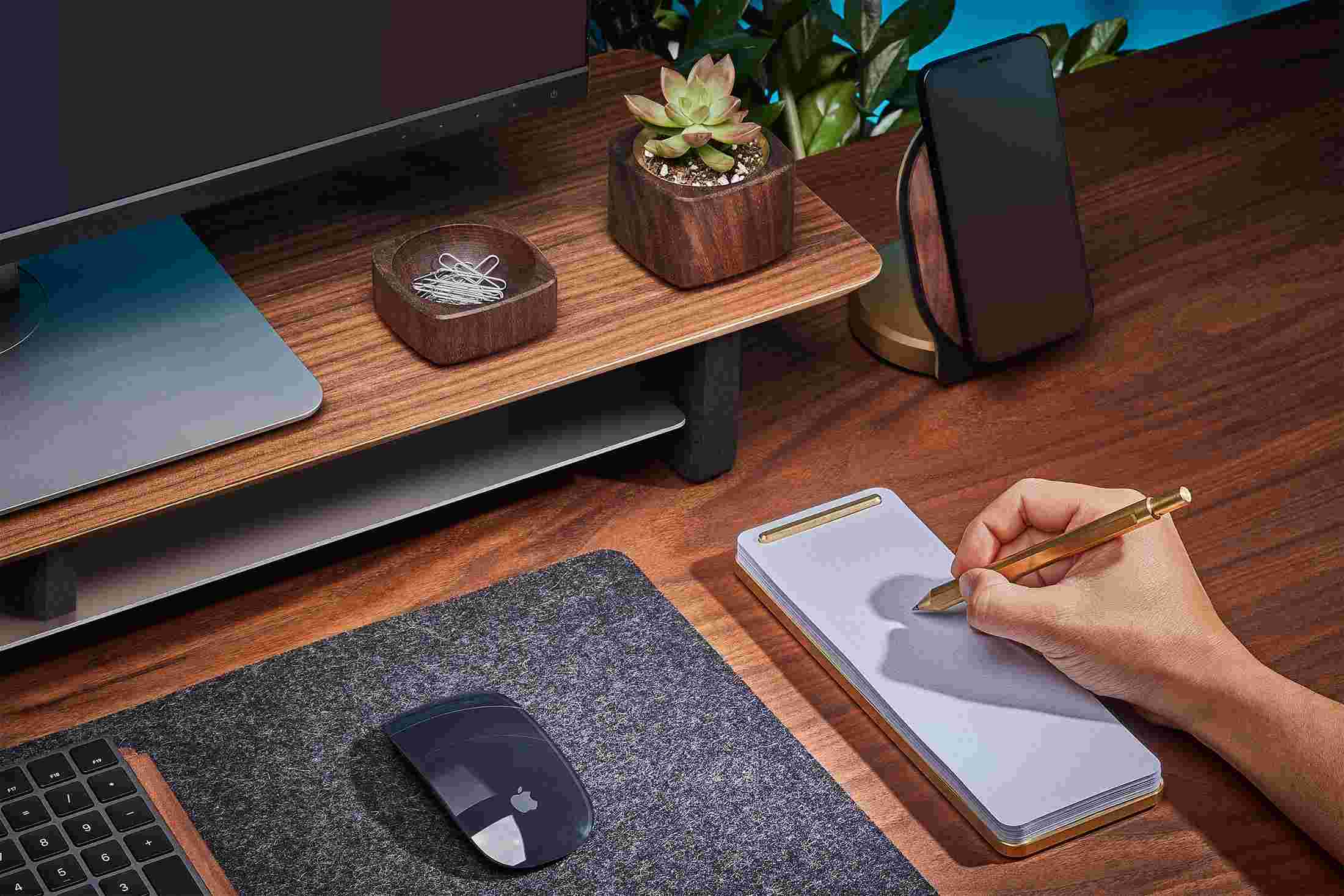 Modern desk notepad in brass, with walnut desk shelf.