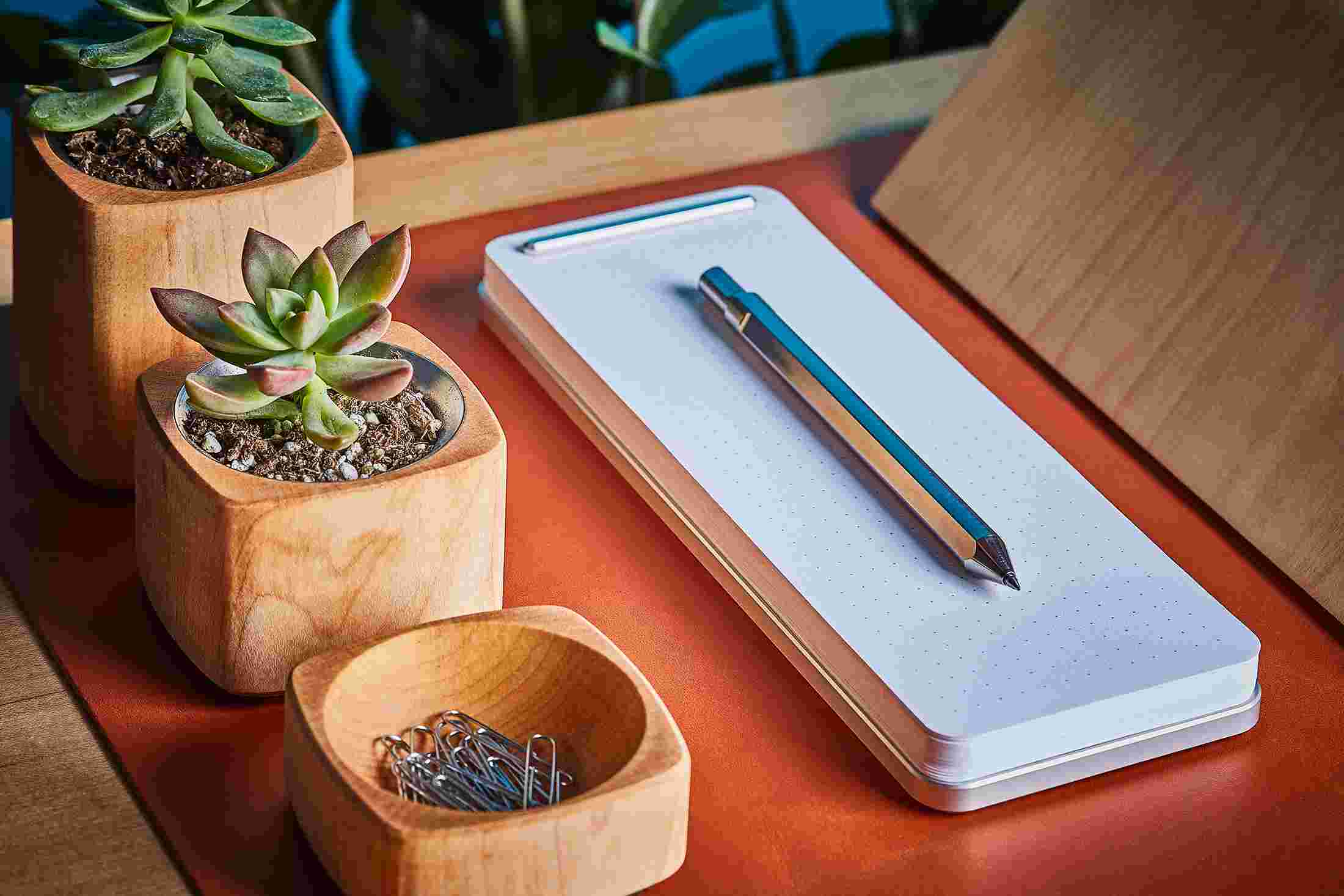 Aluminum looseleaf notepad desk station, with maple wood accessories.