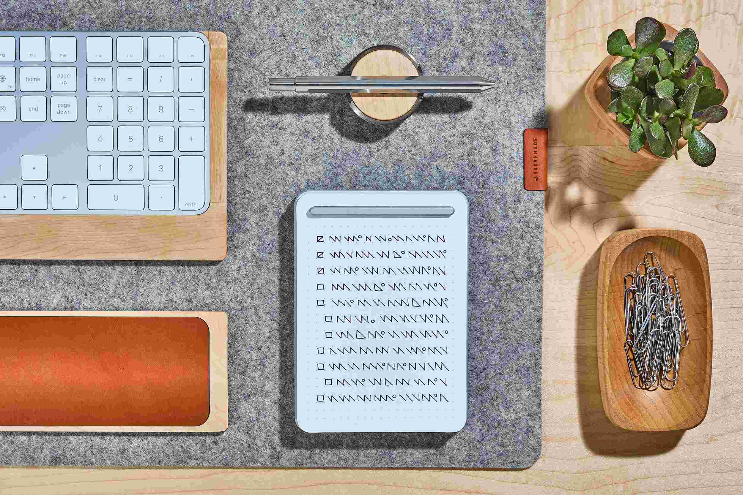 Overhead view of the small silver notepad and matching silver pen set.