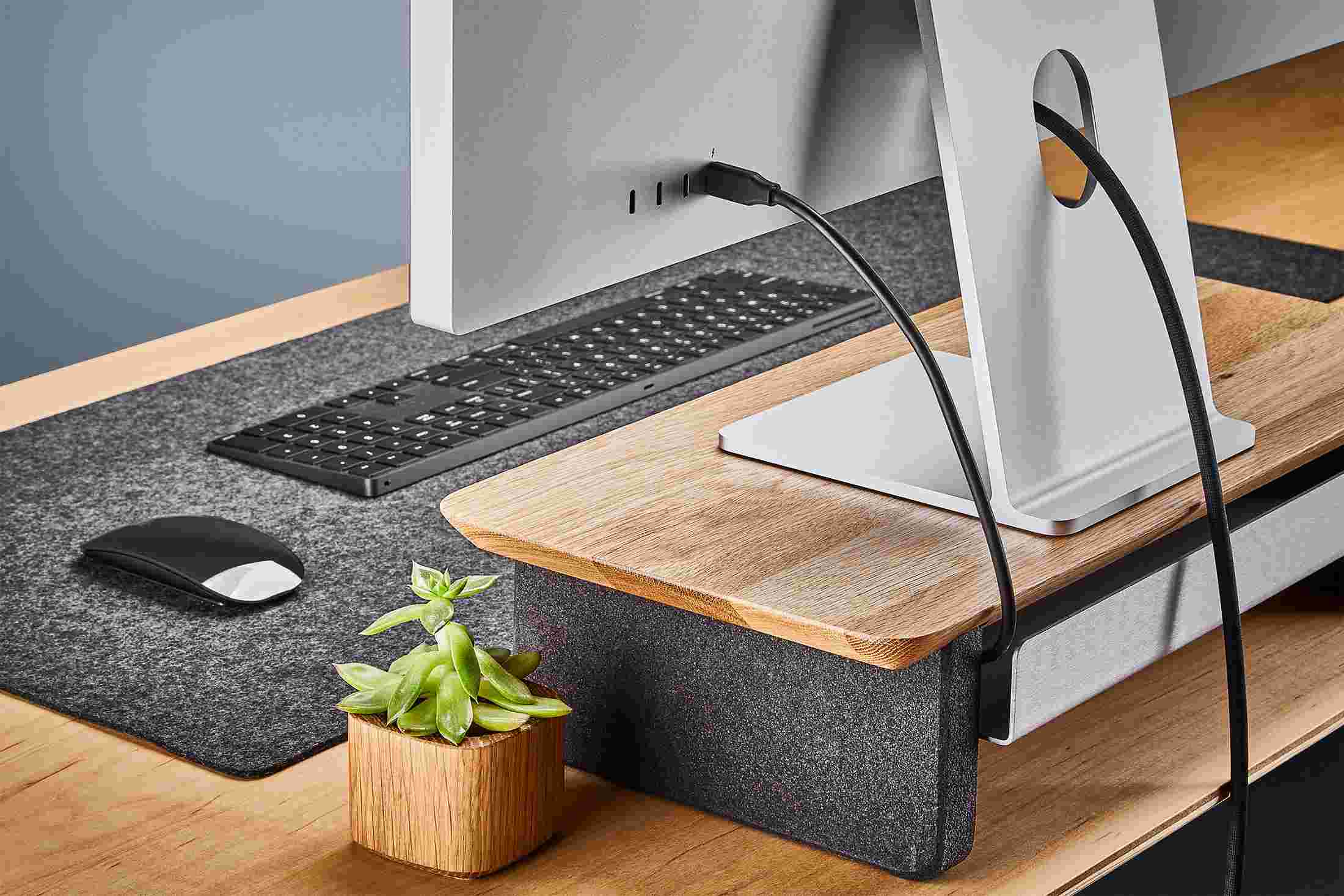 Rear view of the small white oak monitor organizer showing the back edge of the bent metal shelf, designed to keep your stuff in place, while leaving space for hidden cord access.