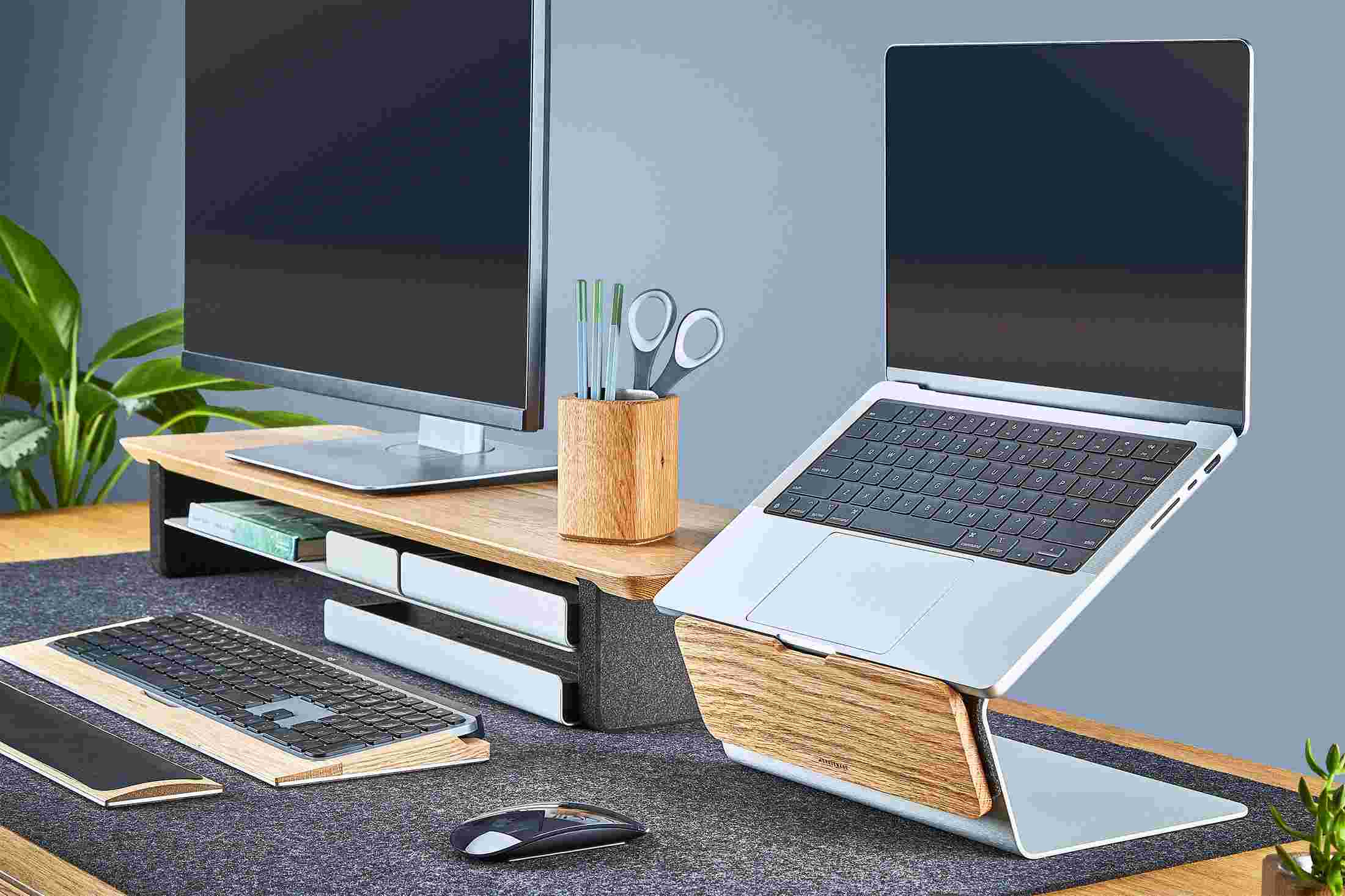 Oak laptop riser with matching oak monitor stand.
