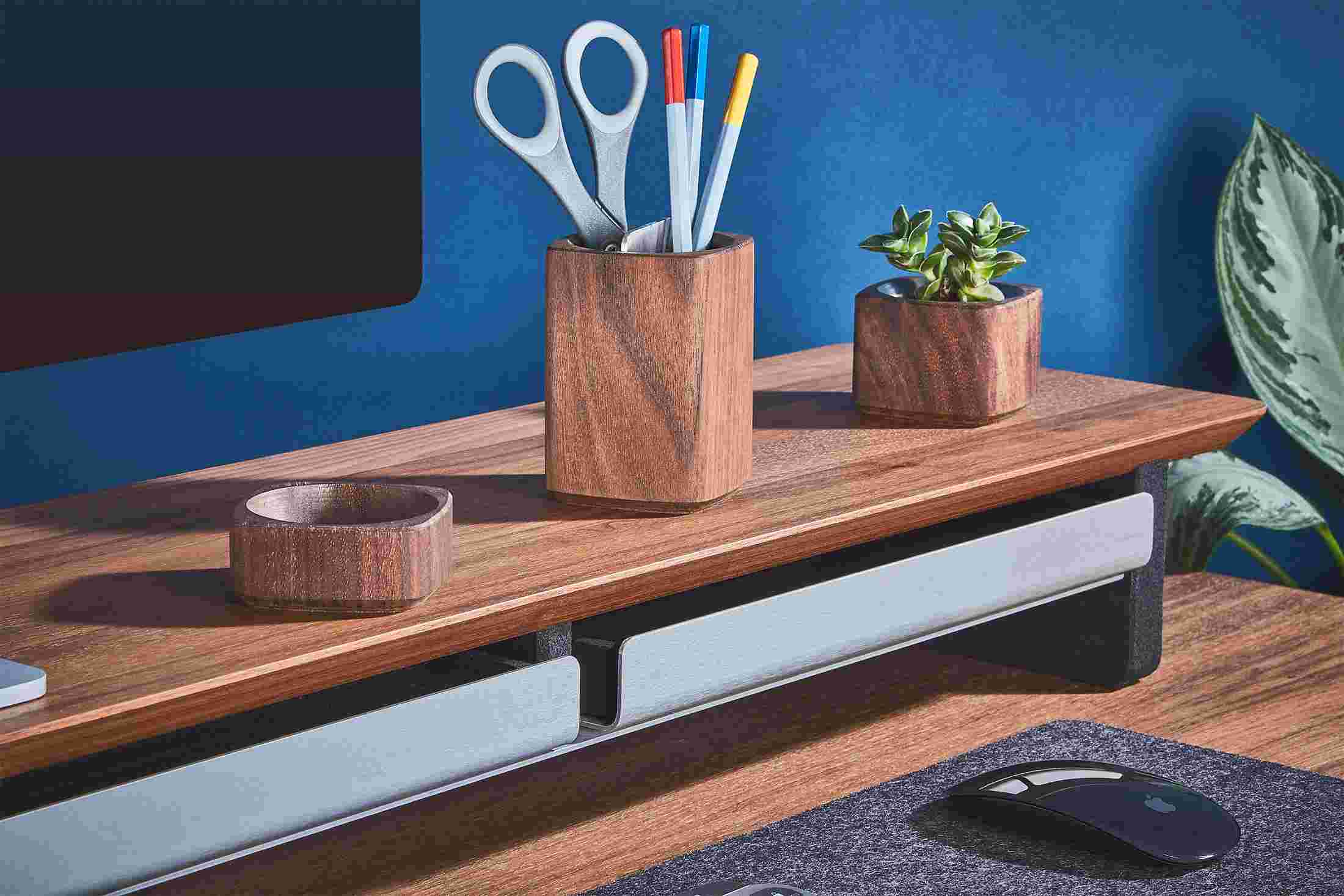 The Dark Paper Tray pushed into the Walnut Desk Shelf, hiding clutter for a minimalist workspace.