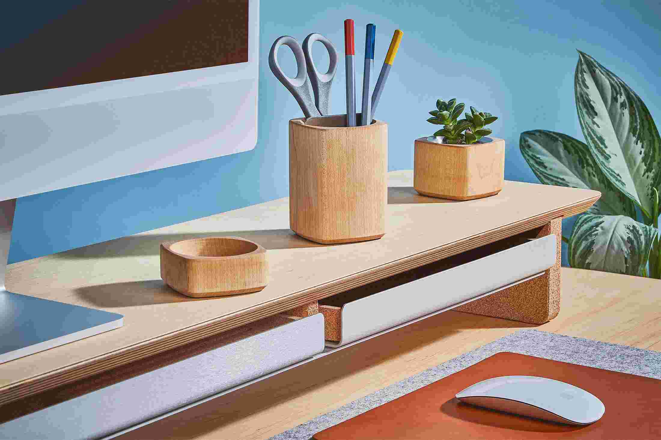 The Light Paper Tray pushed into the Maple Desk Shelf, hiding clutter for a minimalist workspace.