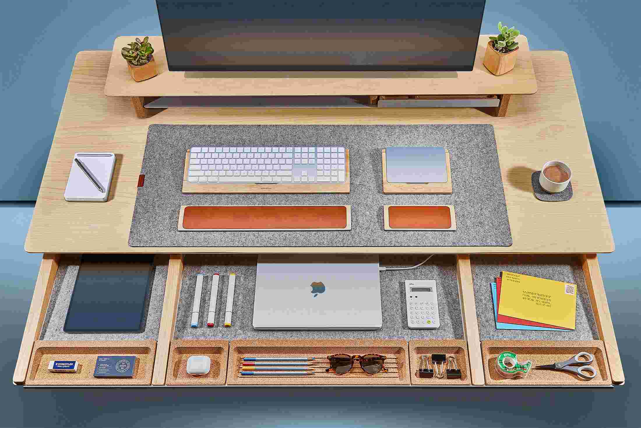 Overhead of the solid maple desk's massive slide-out drawer, with powered spots for laptops and other devices.