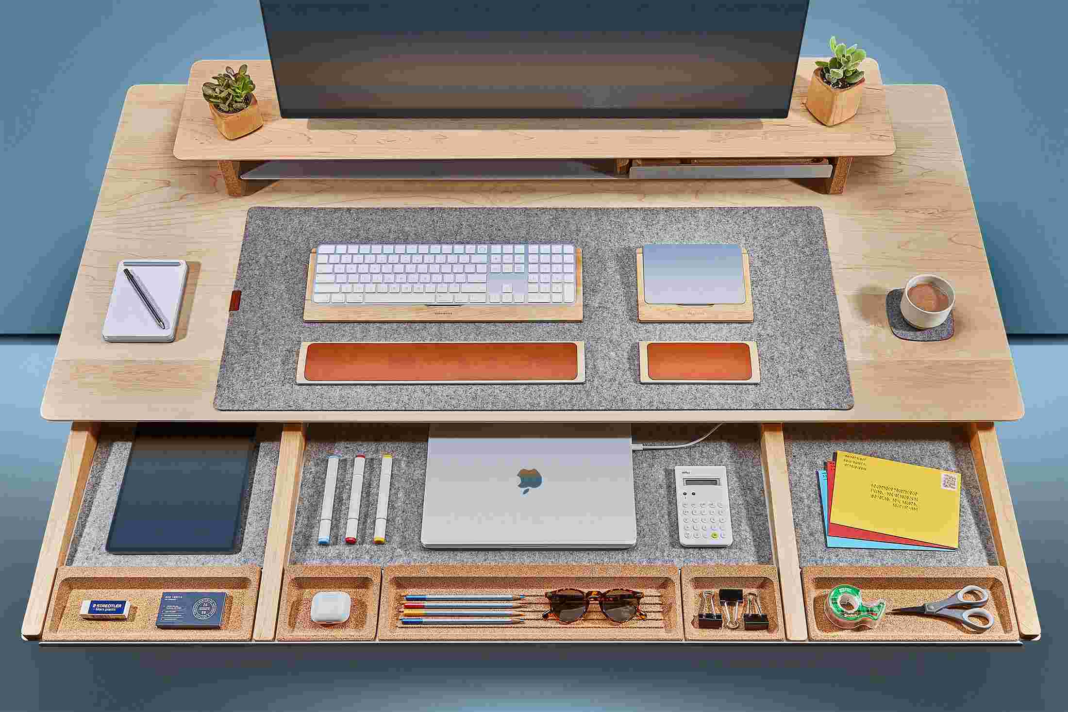 Overhead of the solid maple desk's massive slide-out drawer, with powered spots for laptops and other devices.