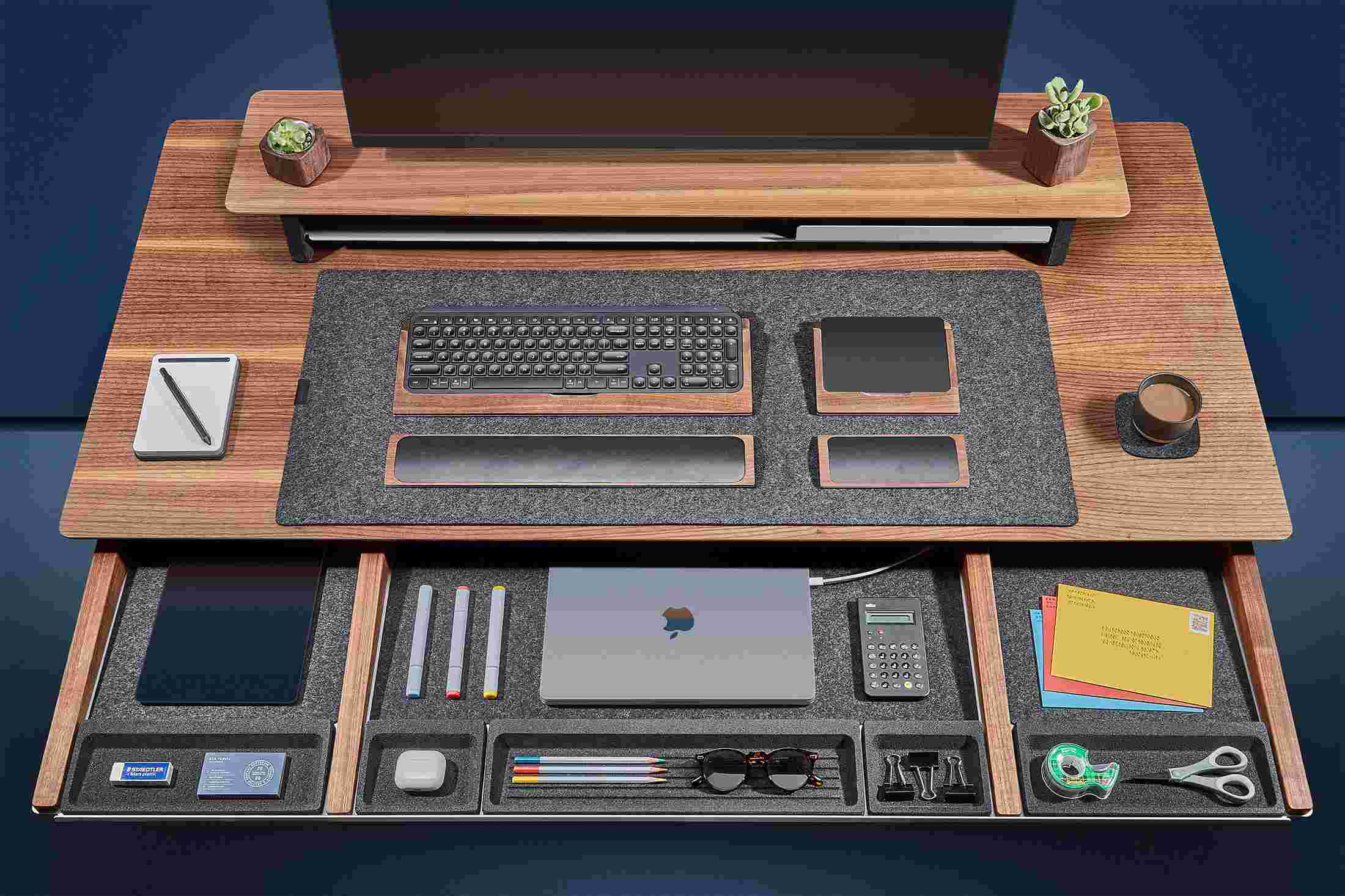 Overhead of the solid walnut desk's massive slide-out drawer, with powered spots for laptops and other devices