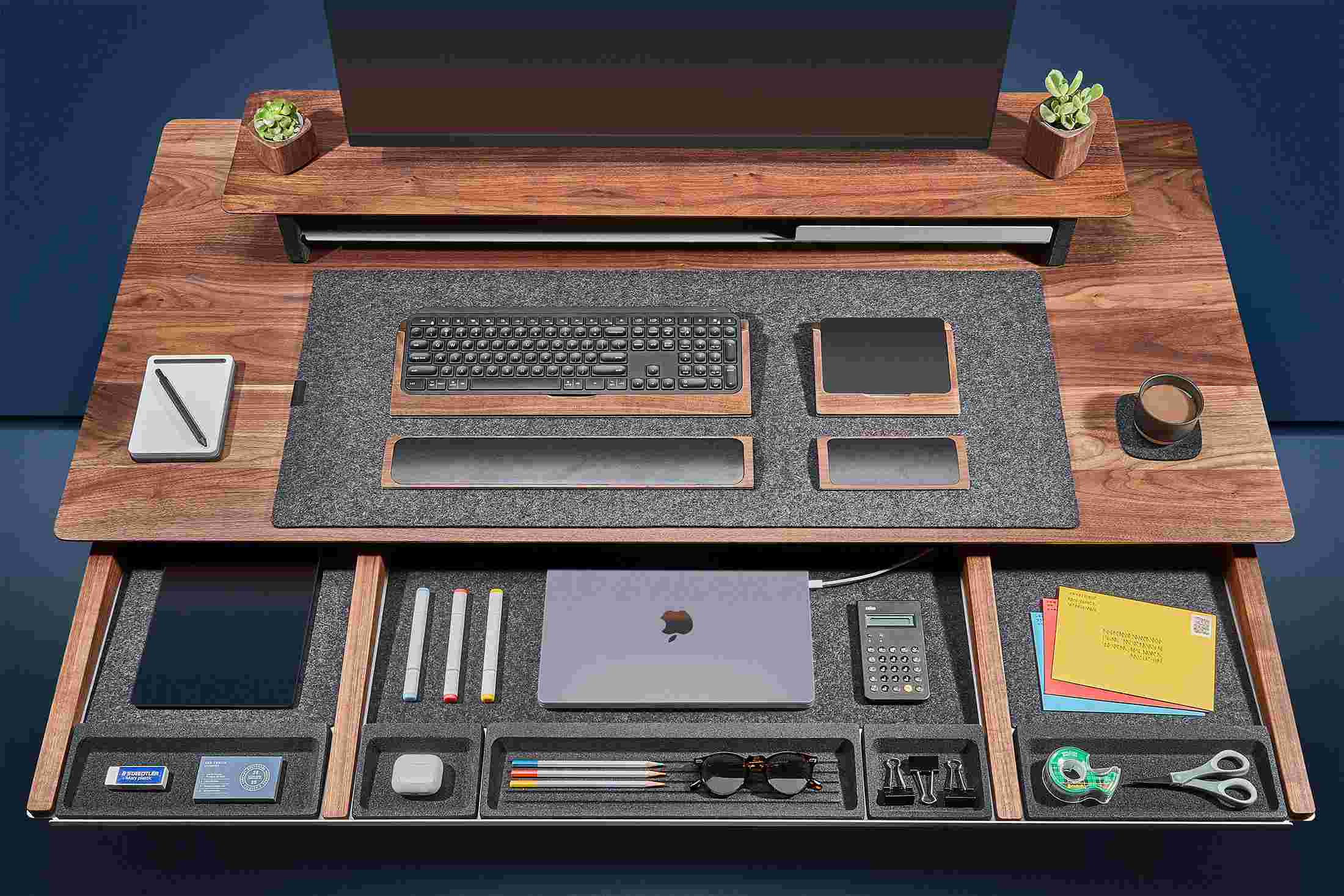 Overhead of the solid walnut desk's massive slide-out drawer, with powered spots for laptops and other devices
