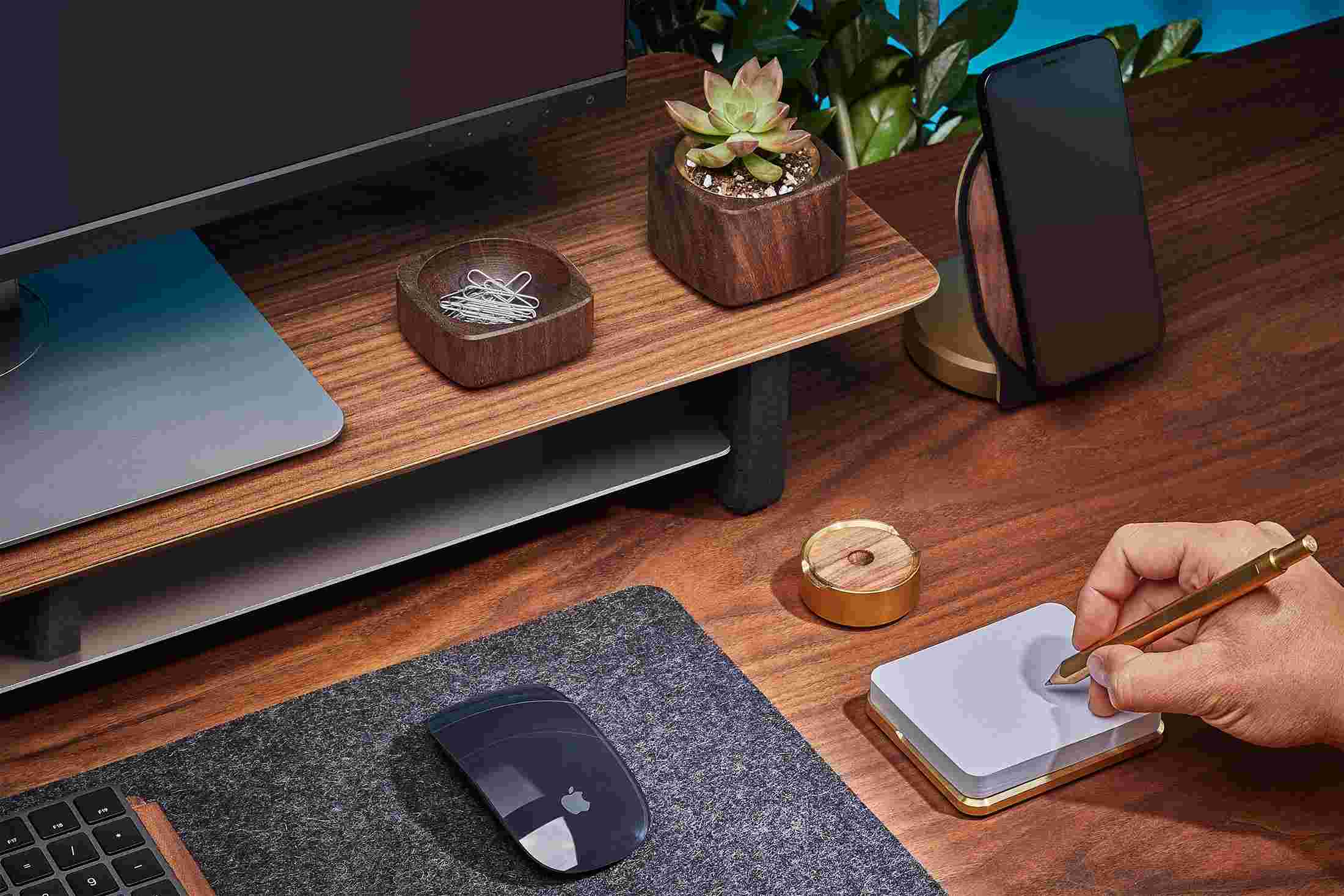 Premium brass sticky note pad as part of the walnut wood desk collection feature wood monitor stand.