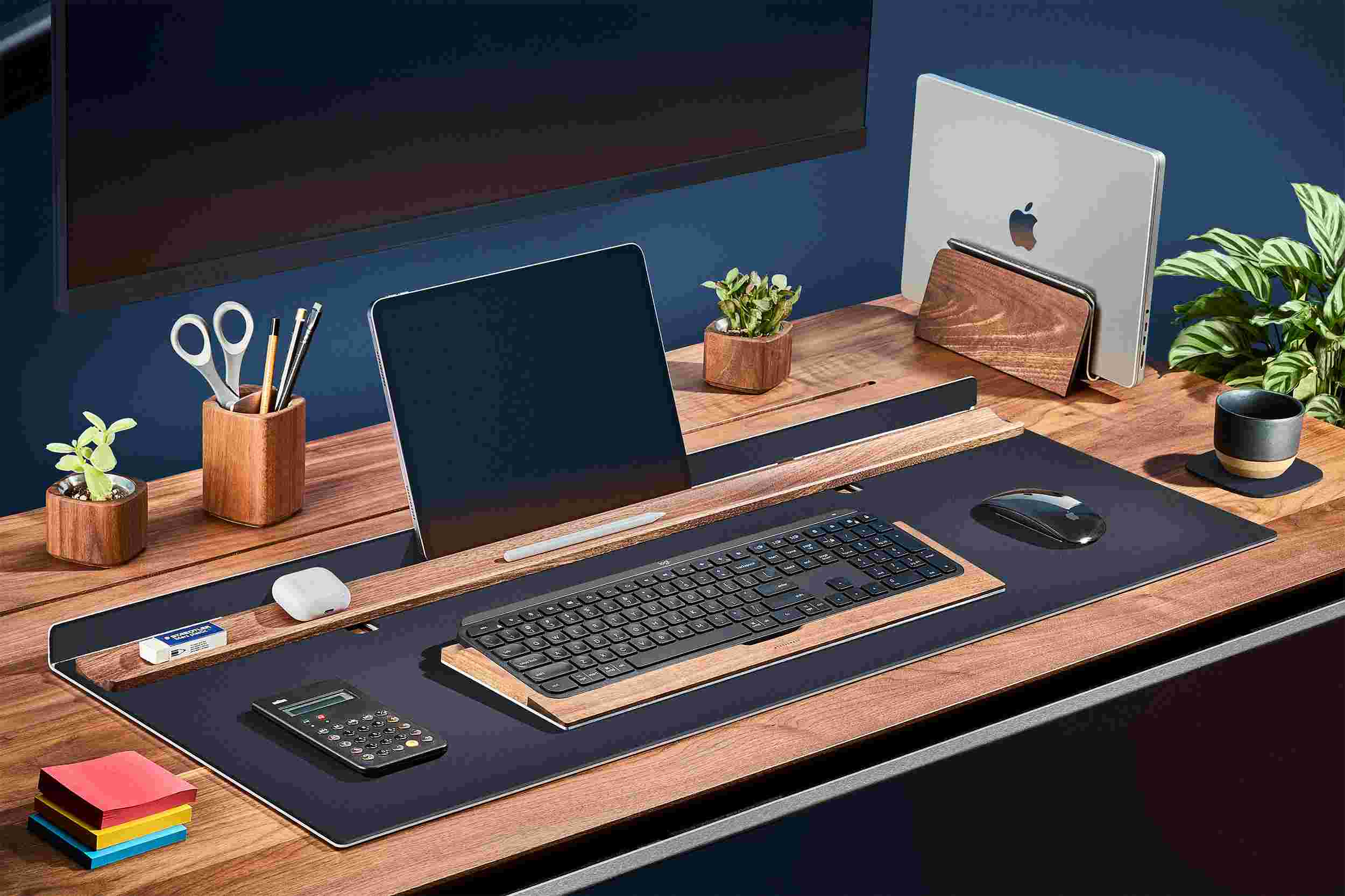Matte black desk station with matching wood keyboard tray and MacBook stand.