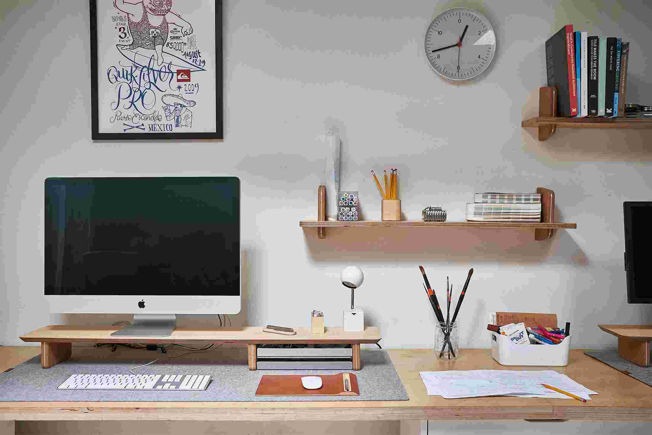 Maple wood monitor stand with matching wall shelving.