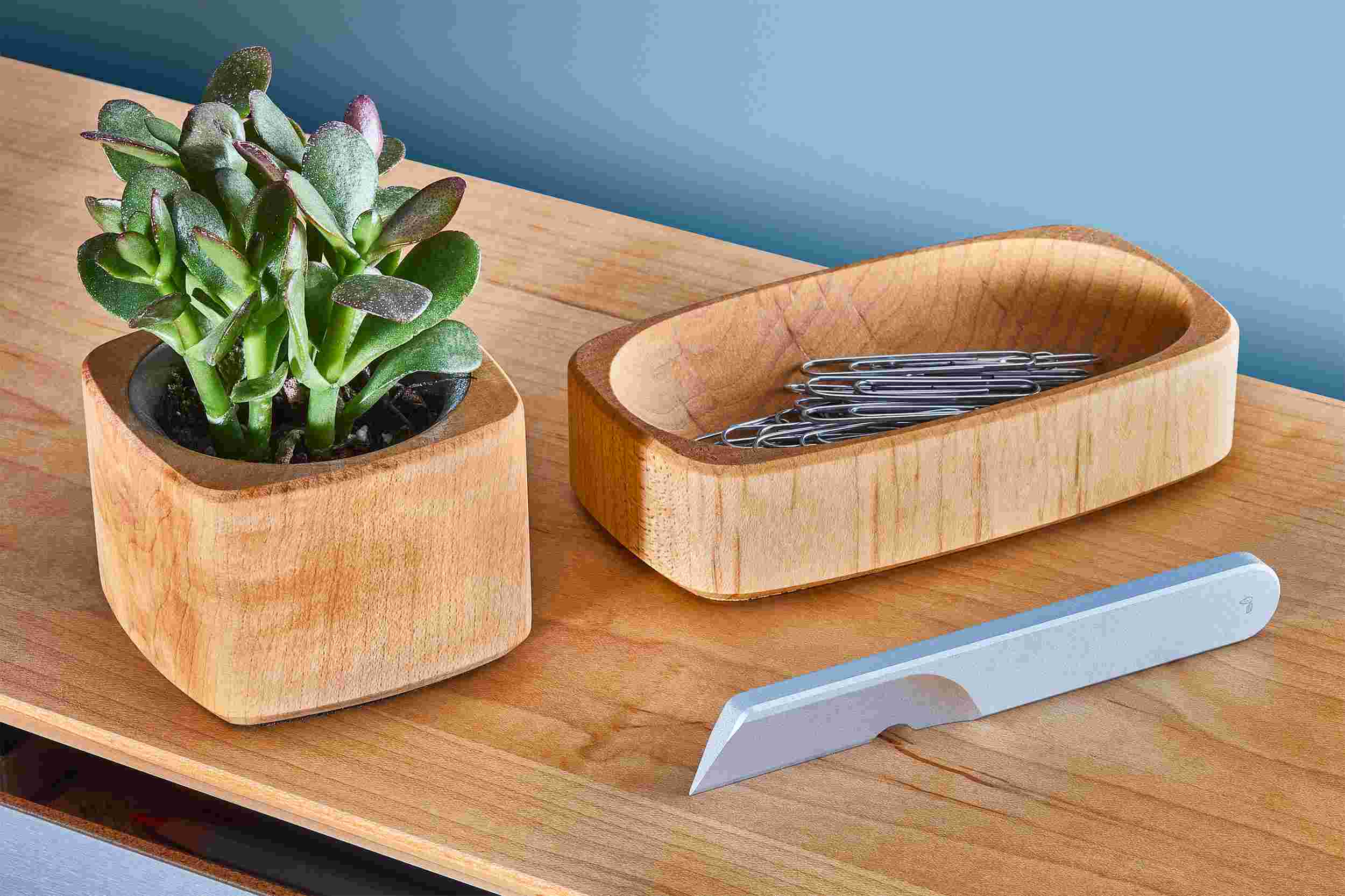 Silver task knife on maple desk shelf with matching planter and dish.