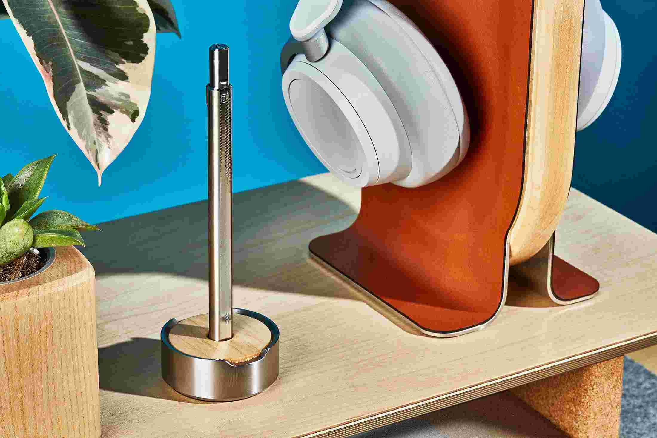 The Grovemade Titanium Pen and Maple Pen Stand, on a lighter, maple desktop.