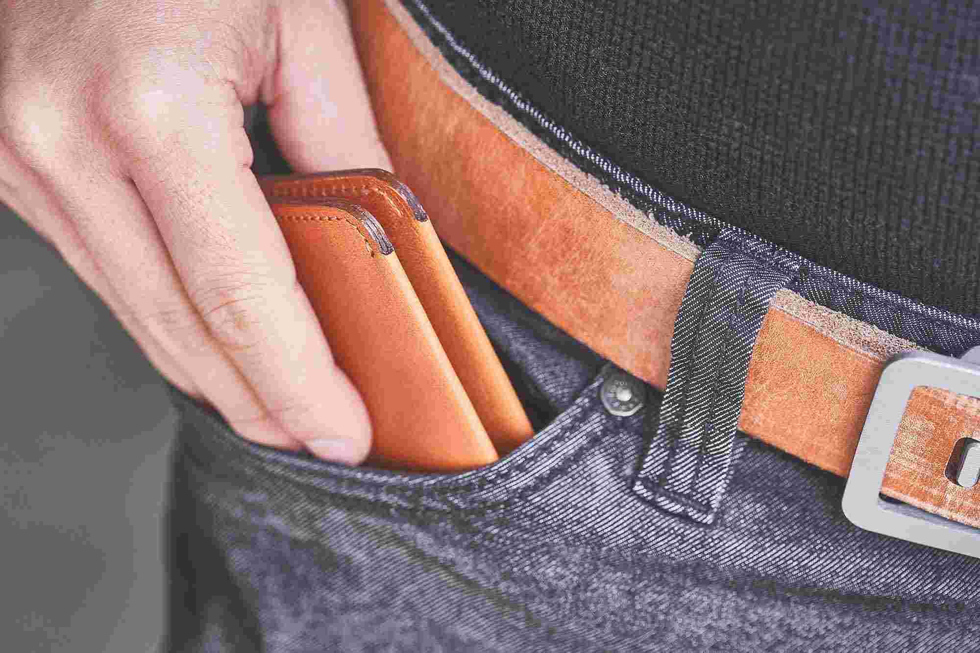 Compact tan leather bifold wallet fits easily in front pants pocket.