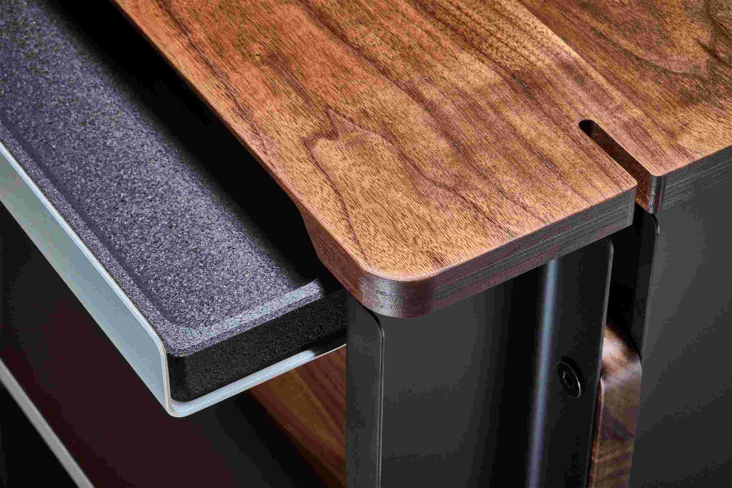 Closeup detail of the hardwood walnut and blackened cork drawer.
