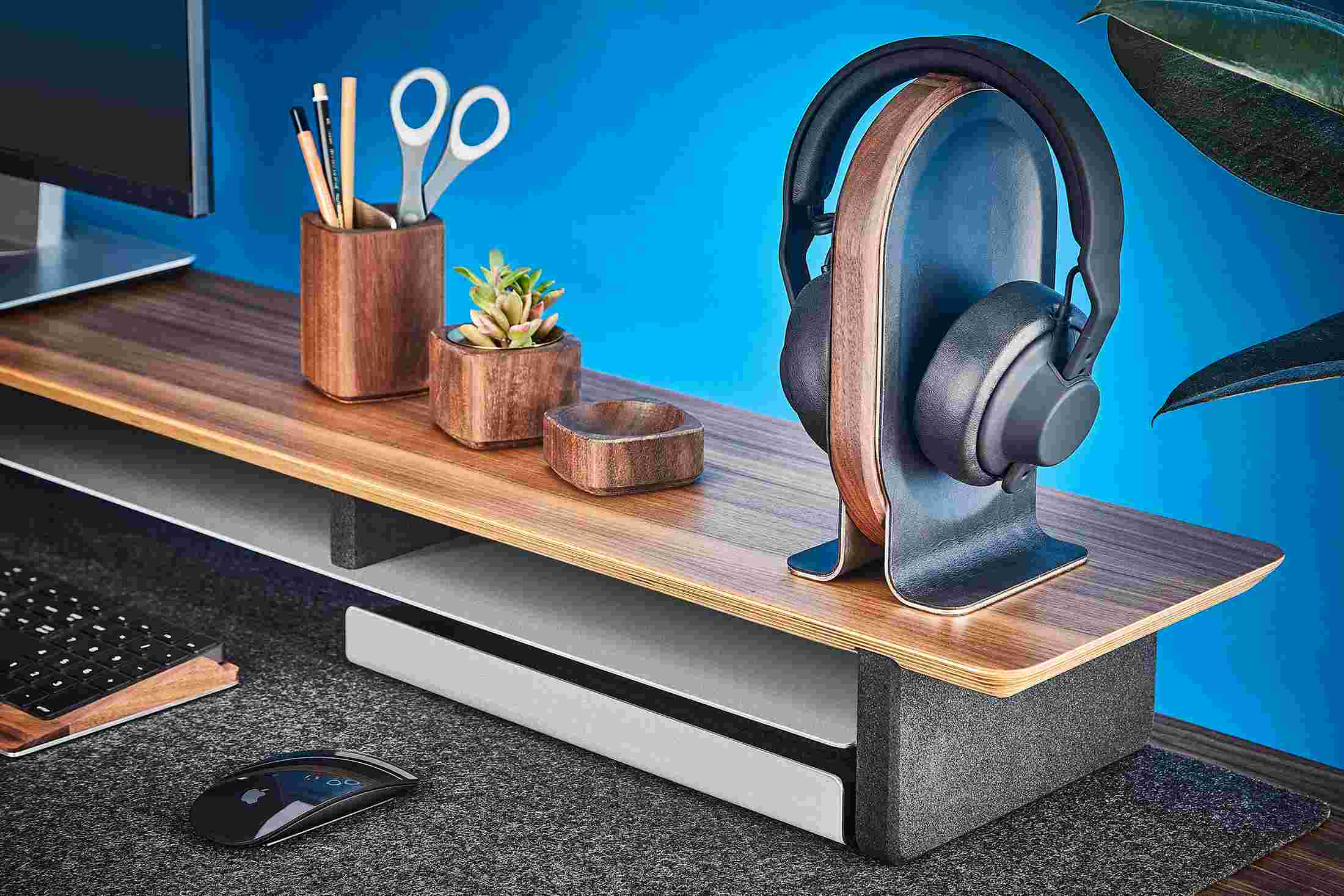 Walnut wood headphone stand with premium black leather inlay on the Grovemade Wood Desk Shelf for iMac.