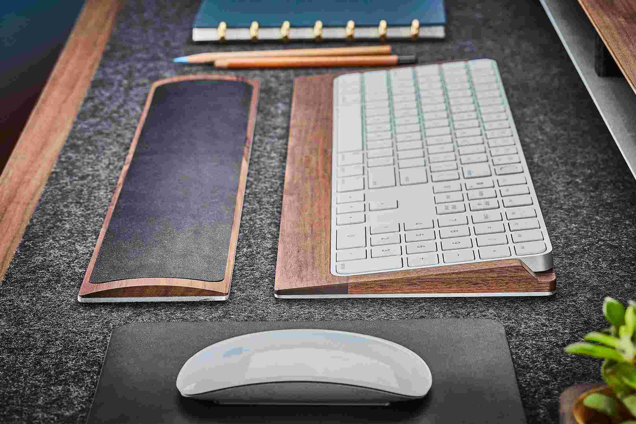 Side view detail of the steel and walnut wood keyboard tray.
