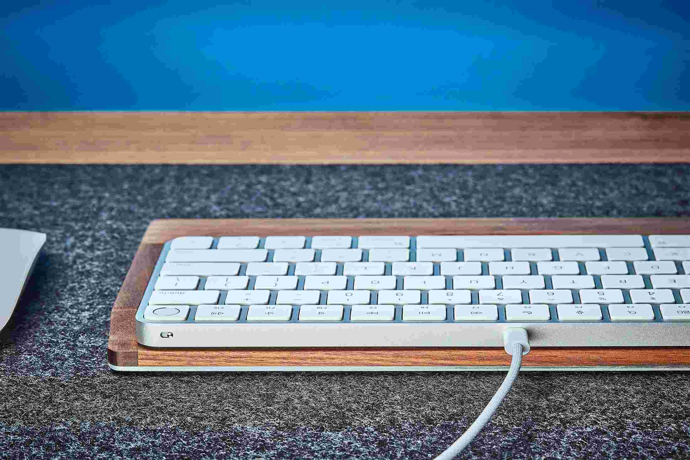 Rear view detail of the steel and walnut wood keyboard tray.