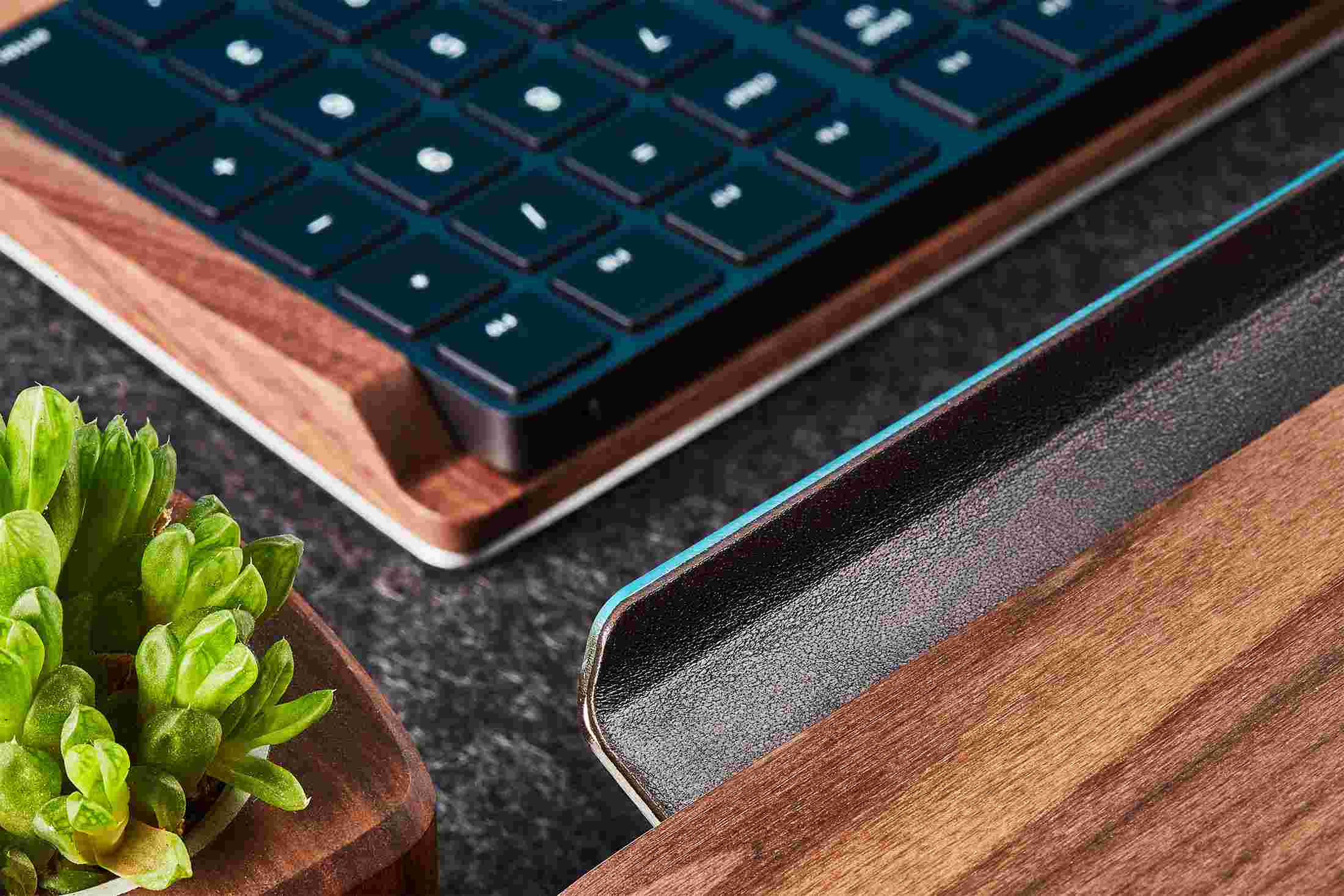 Detail of the leather, steel, and walnut laptop stand. 