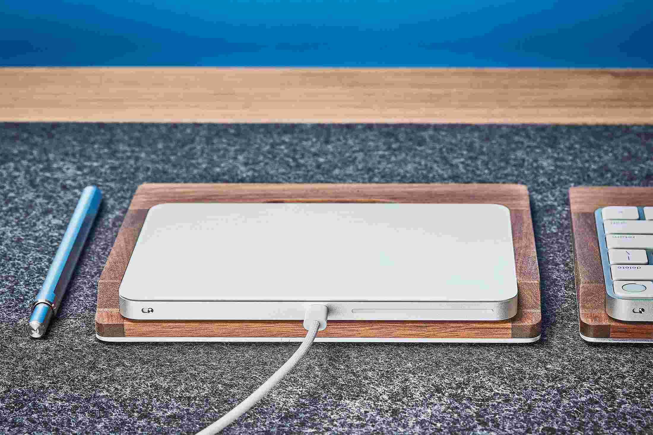 Rear view detail of the steel and walnut wood trackpad tray.