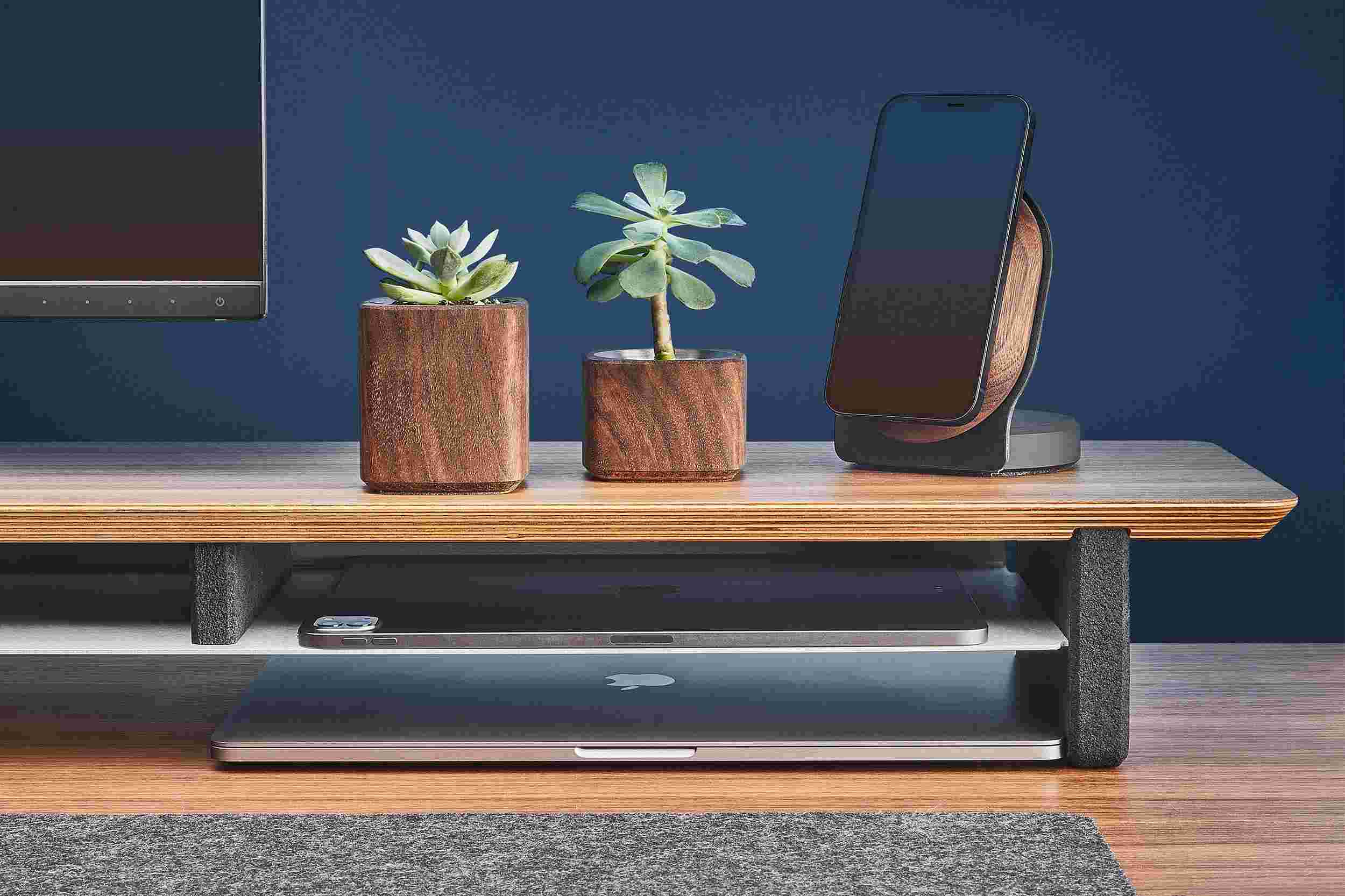 The desk shelf's integrated storage shelf holding both a 12.9 inch iPad Pro and 9.7 inch iPad.