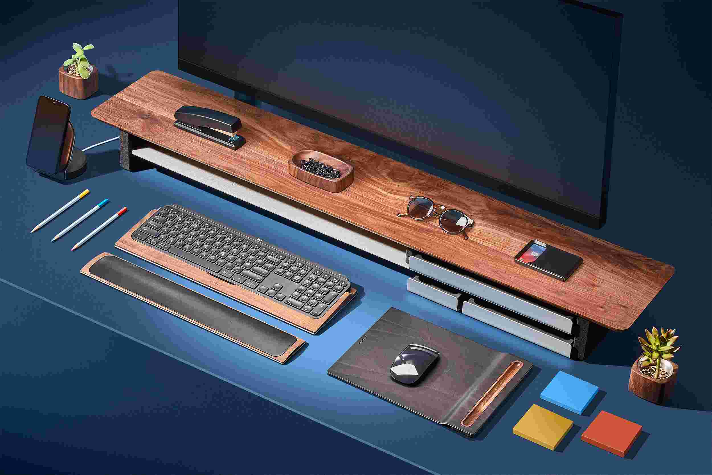 Large walnut desk shelf on bright blue background with matching wood accessories.