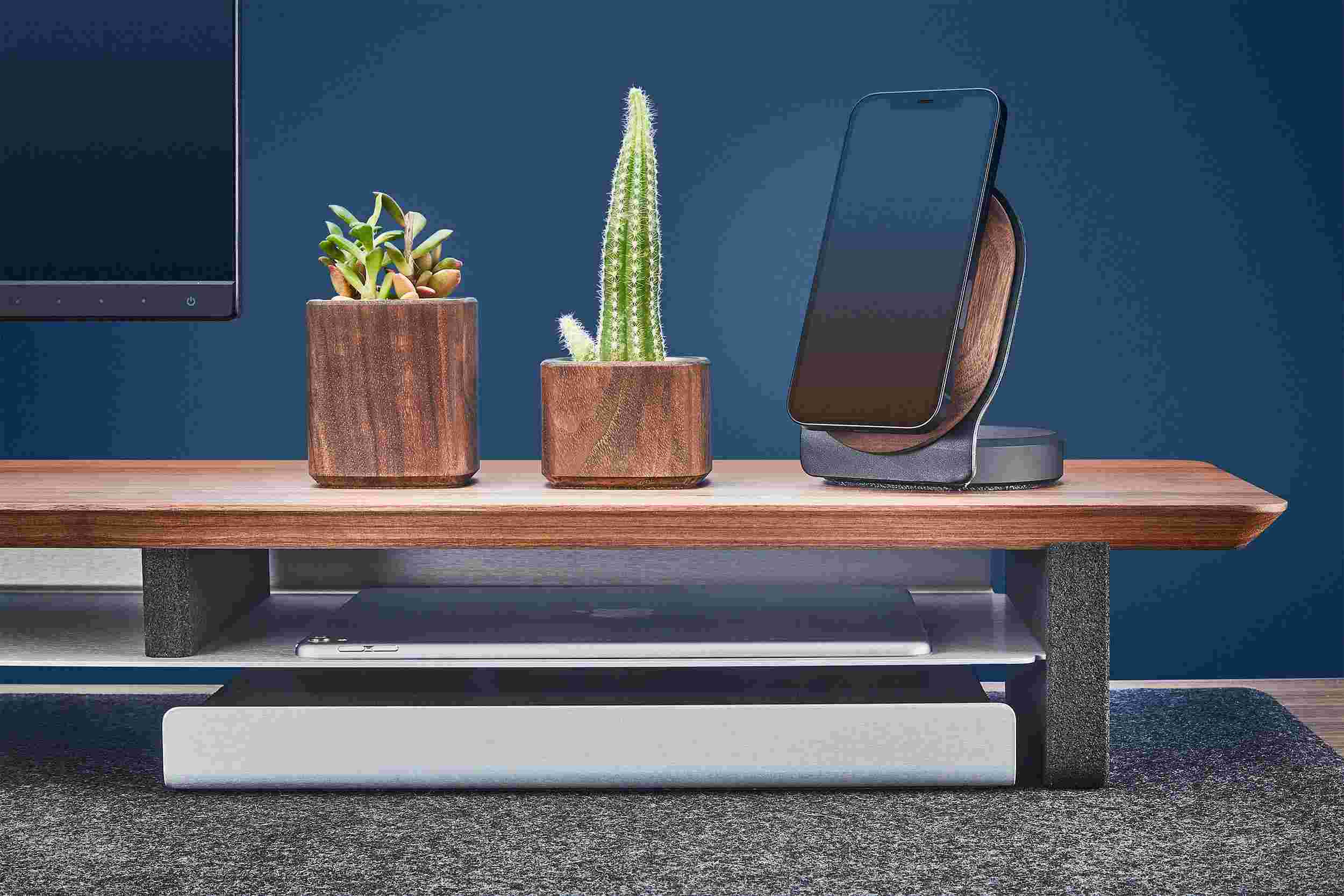 The desk shelf's integrated storage shelf holding both a 12.9 inch iPad Pro and 9.7 inch iPad.