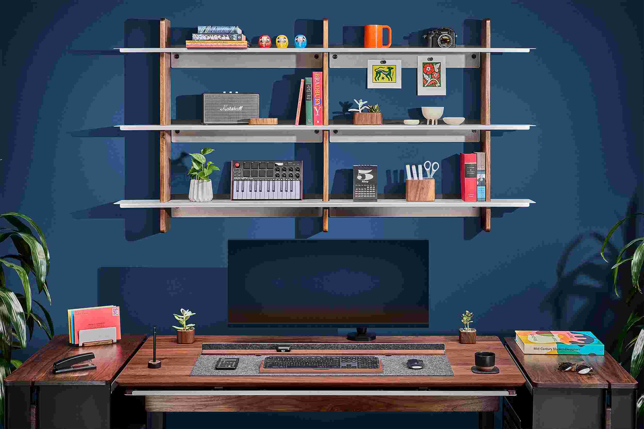 Straight on showing the triple shelf 72" wide walnut wall shelf above matching premium walnut desk.