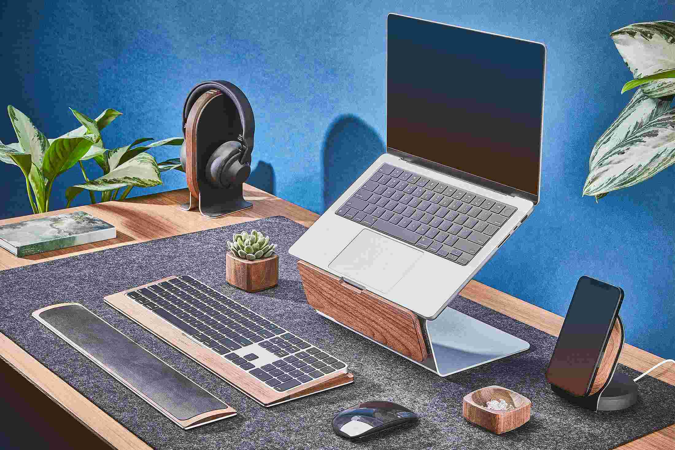 Walnut MacBook stand used as primary work station.