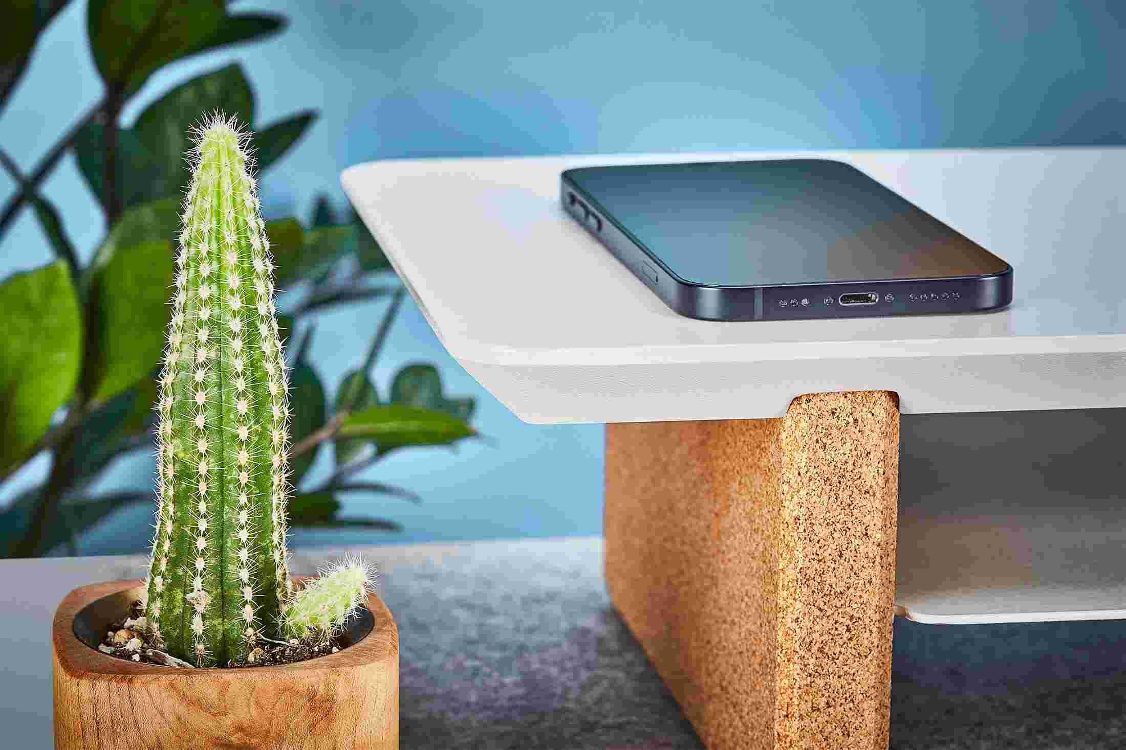 Detail of the beveled corner of the Matte White Desk Shelf with natural cork legs.