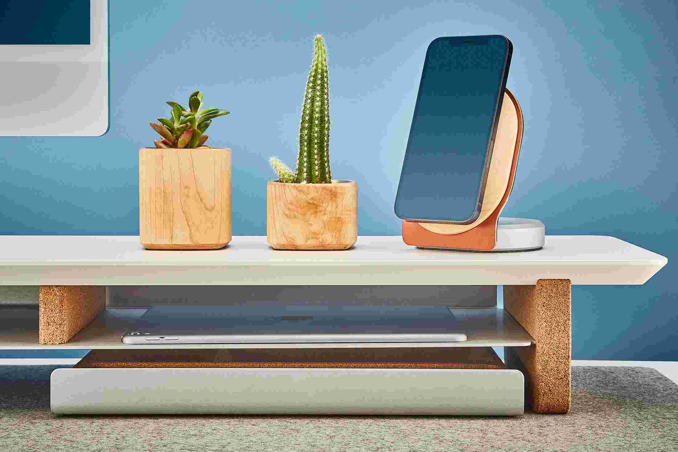 The desk shelf's integrated storage shelf holding both a 12.9 inch iPad Pro and 9.7 inch iPad.
