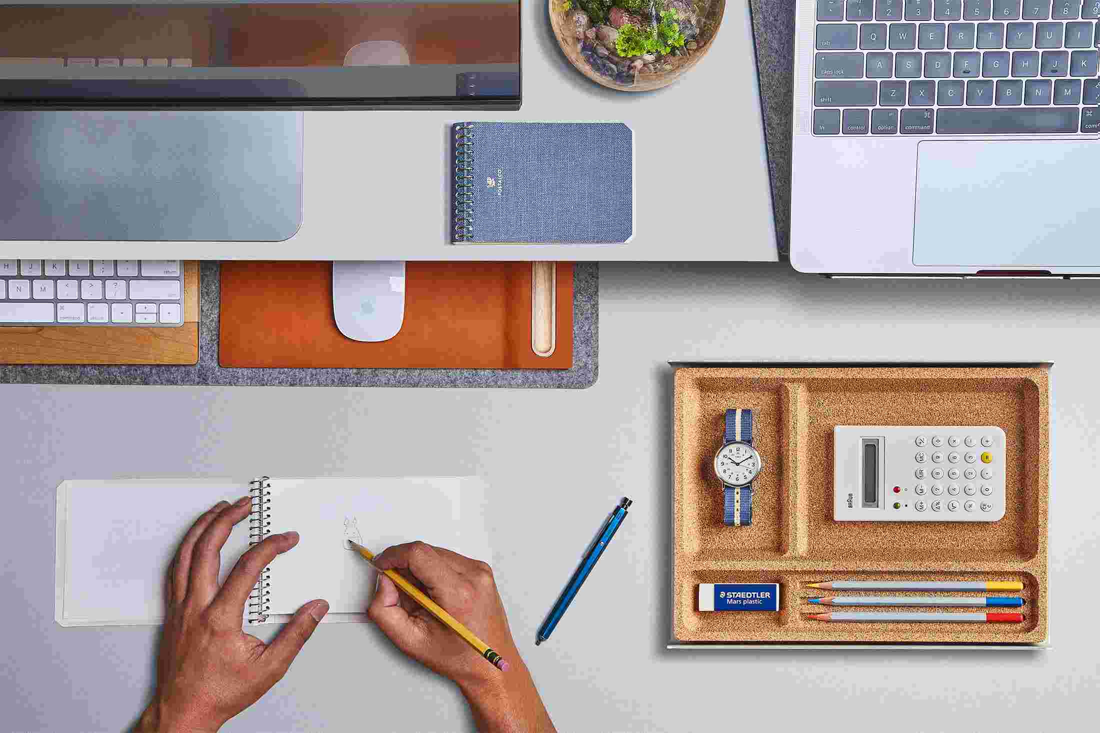 Overhead of the small desk pad with keyboard and mouse slid under the desk shelf to free up desk space.