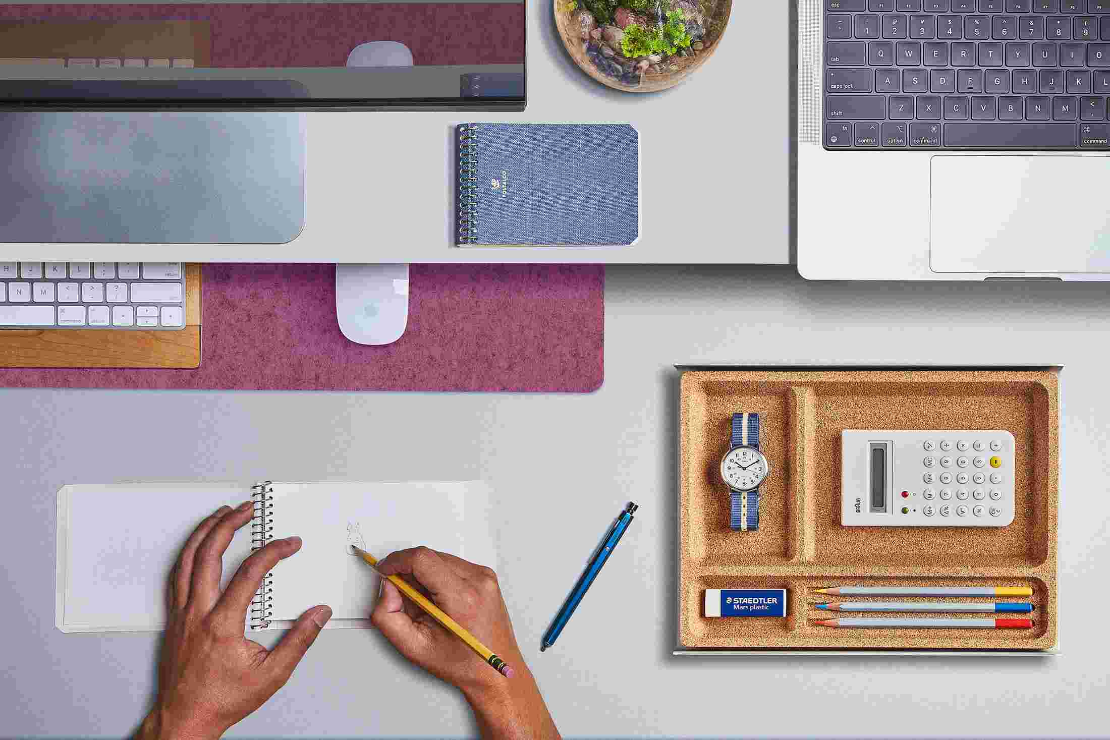 The Small Dark Pink Wool Felt Desk Pad tucked under the Matte White Desk Shelf, creating space to sketch and write.